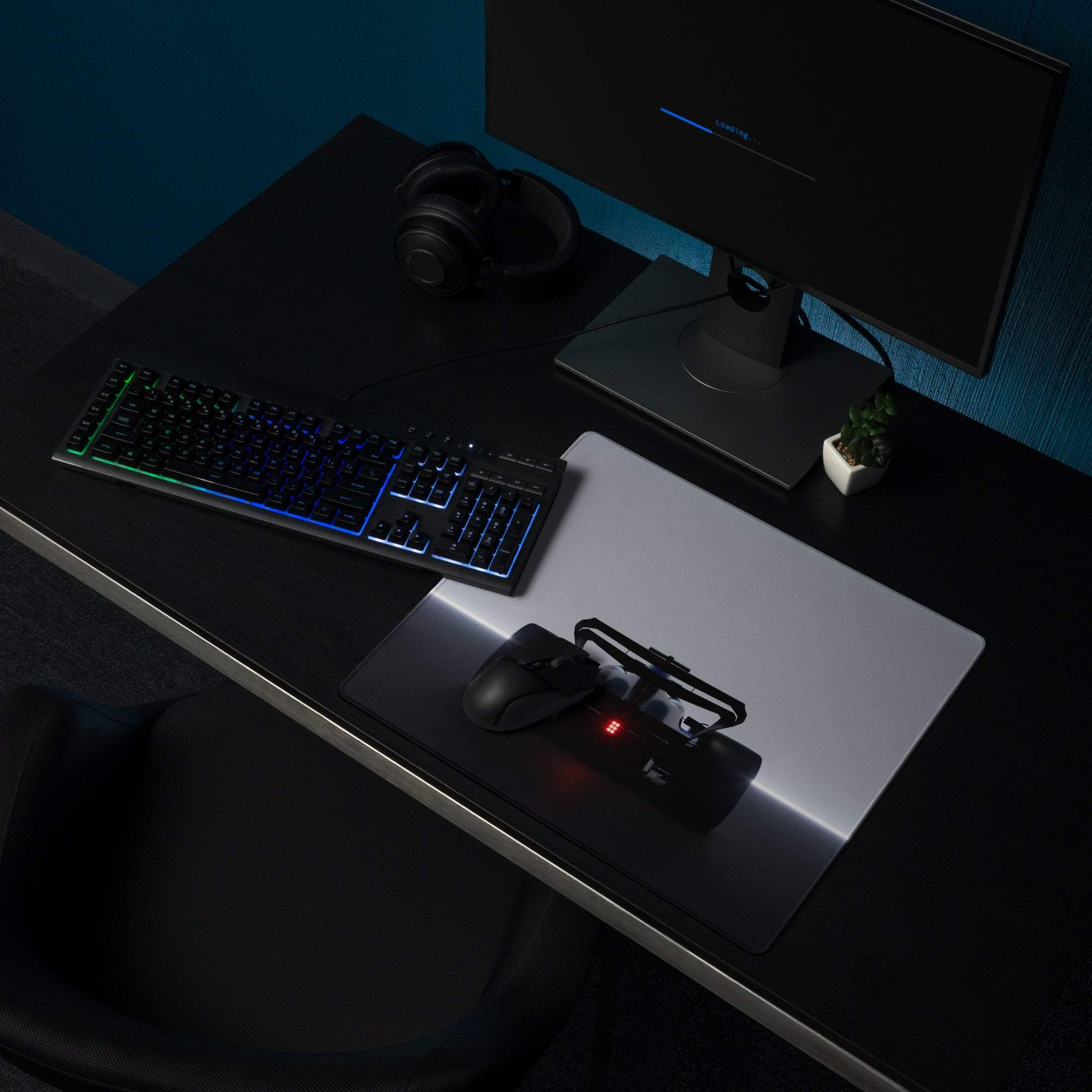 Black gaming mouse with red led light on large gray gaming mouse pad with stitched edge non slip base for esports