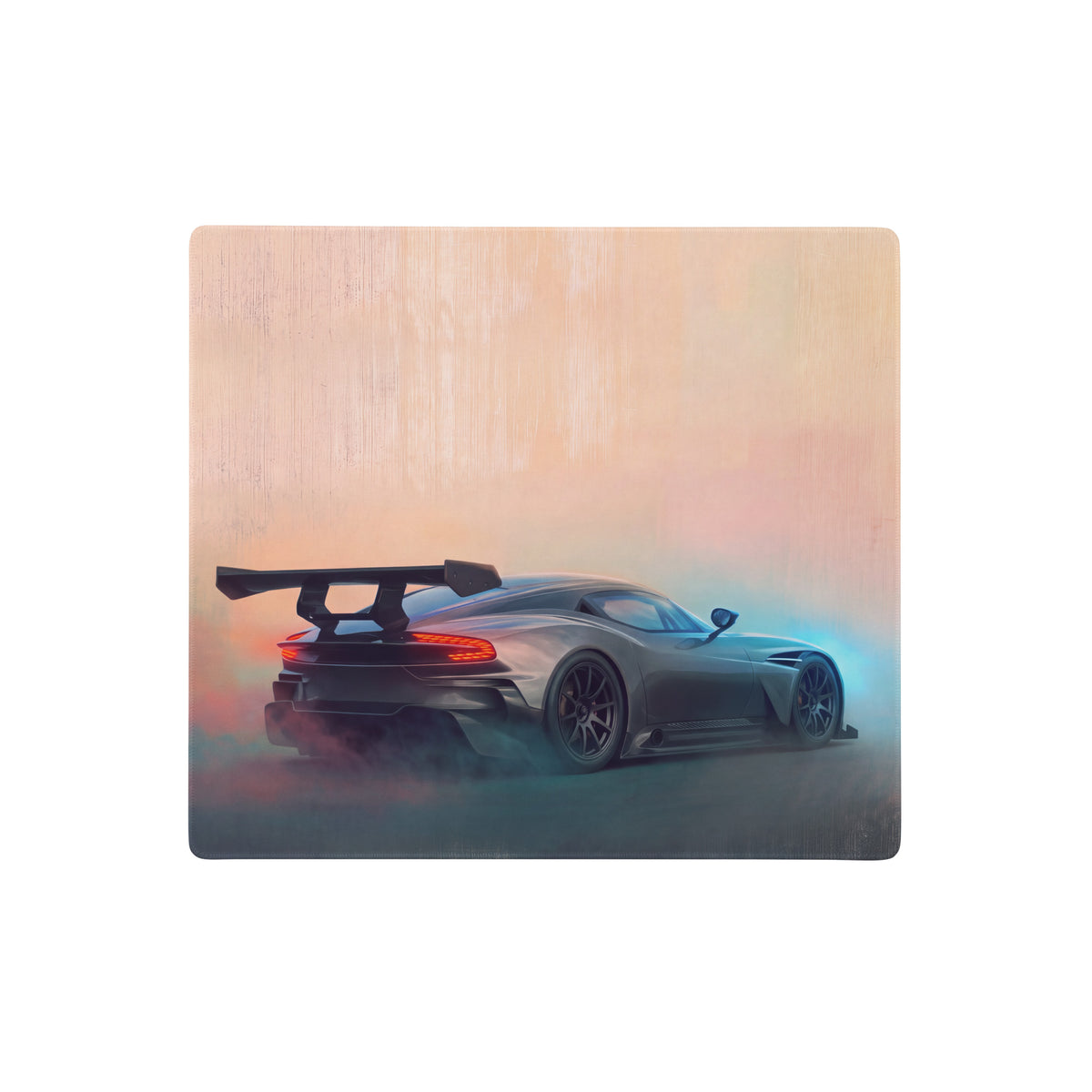 A gunmetal apex desk pad featuring a sleek dark gray aston martin vulcan sports car with rear spoiler and glowing taillights