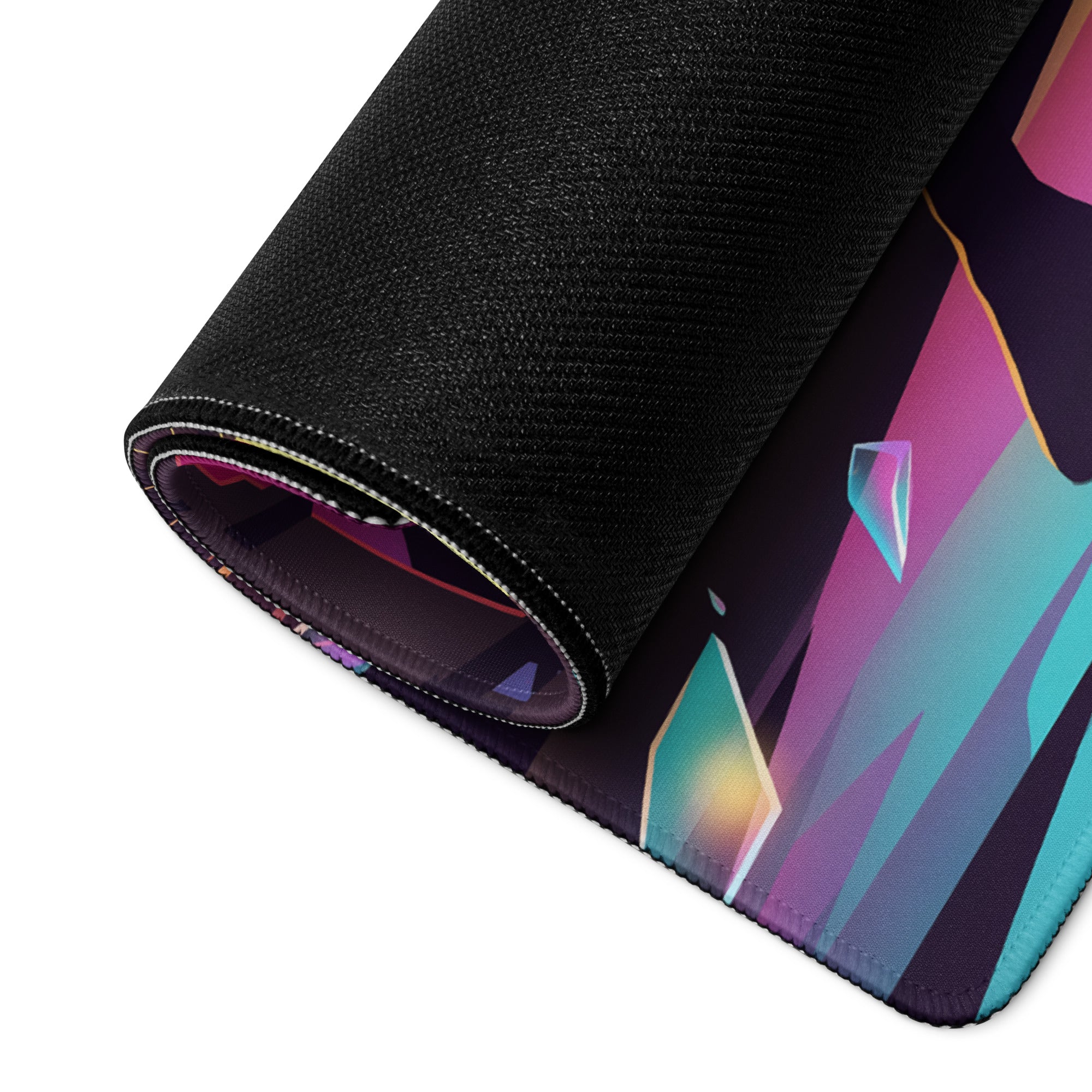A rolled-up vaporwave neon city mouse pad with vibrant purple and teal geometric crystal design on black fabric
