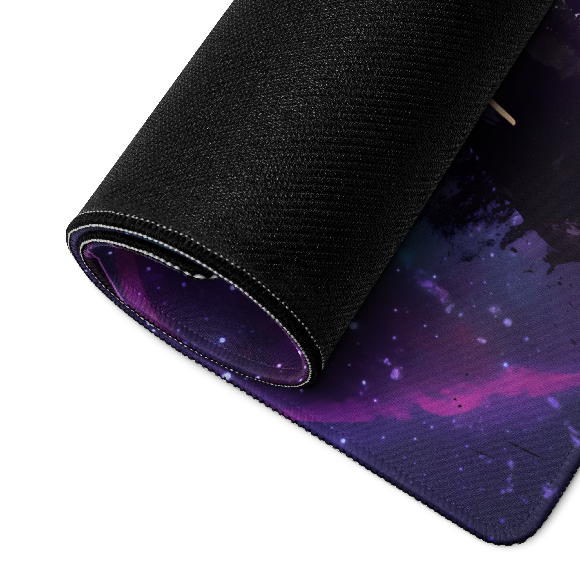 Rolled-up black gaming mousepad with vibrant purple and blue cosmic nebula design for vaporwave neon gaming setup
