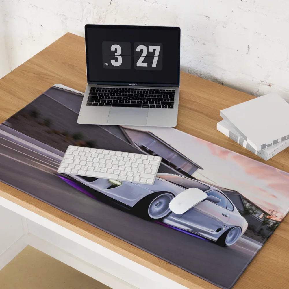A sleek silver-gray Toyota Supra Mk4 sports car graphic printed on a large gaming mouse pad with purple led edge lighting