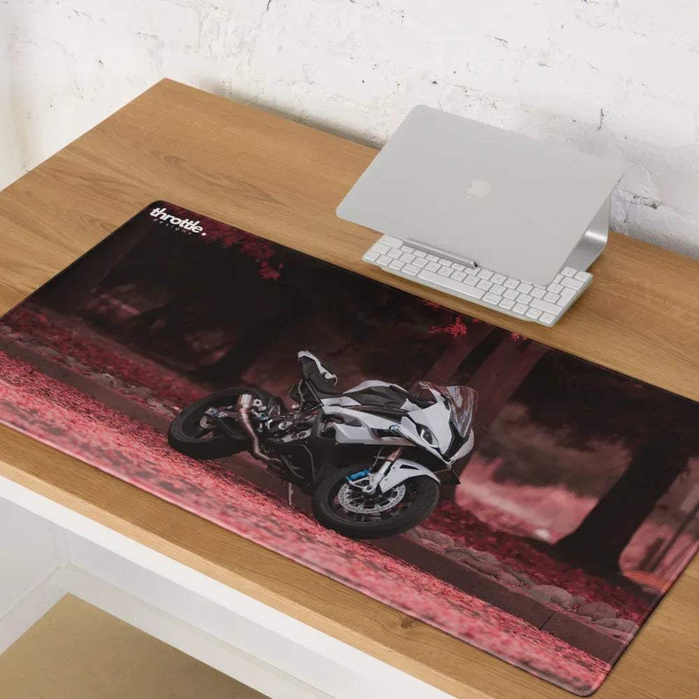 Black and white BMW inspired S1000RR motorcycle graphic on glossy rectangular gaming mouse pad with red foliage accents