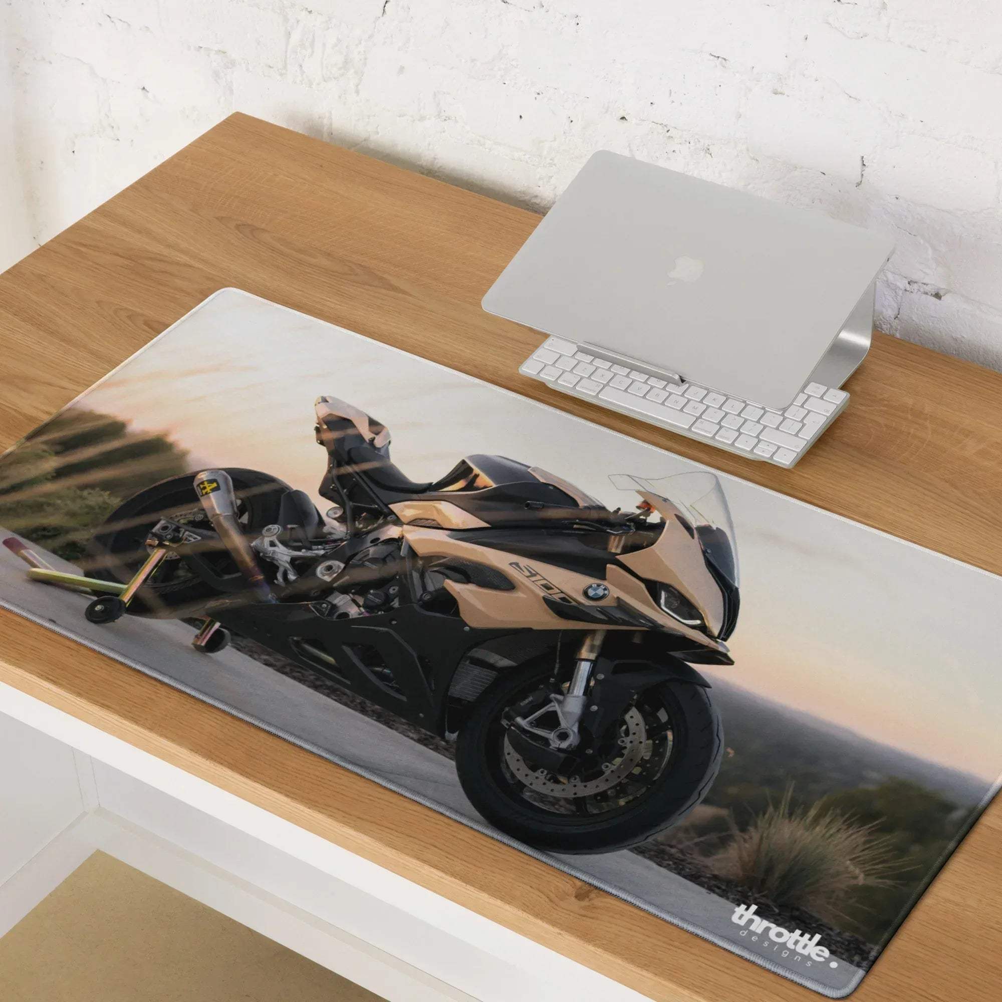 A sleek rectangular large and XL black and gold BMW s1000rr gaming mousepad with throttle brand logo