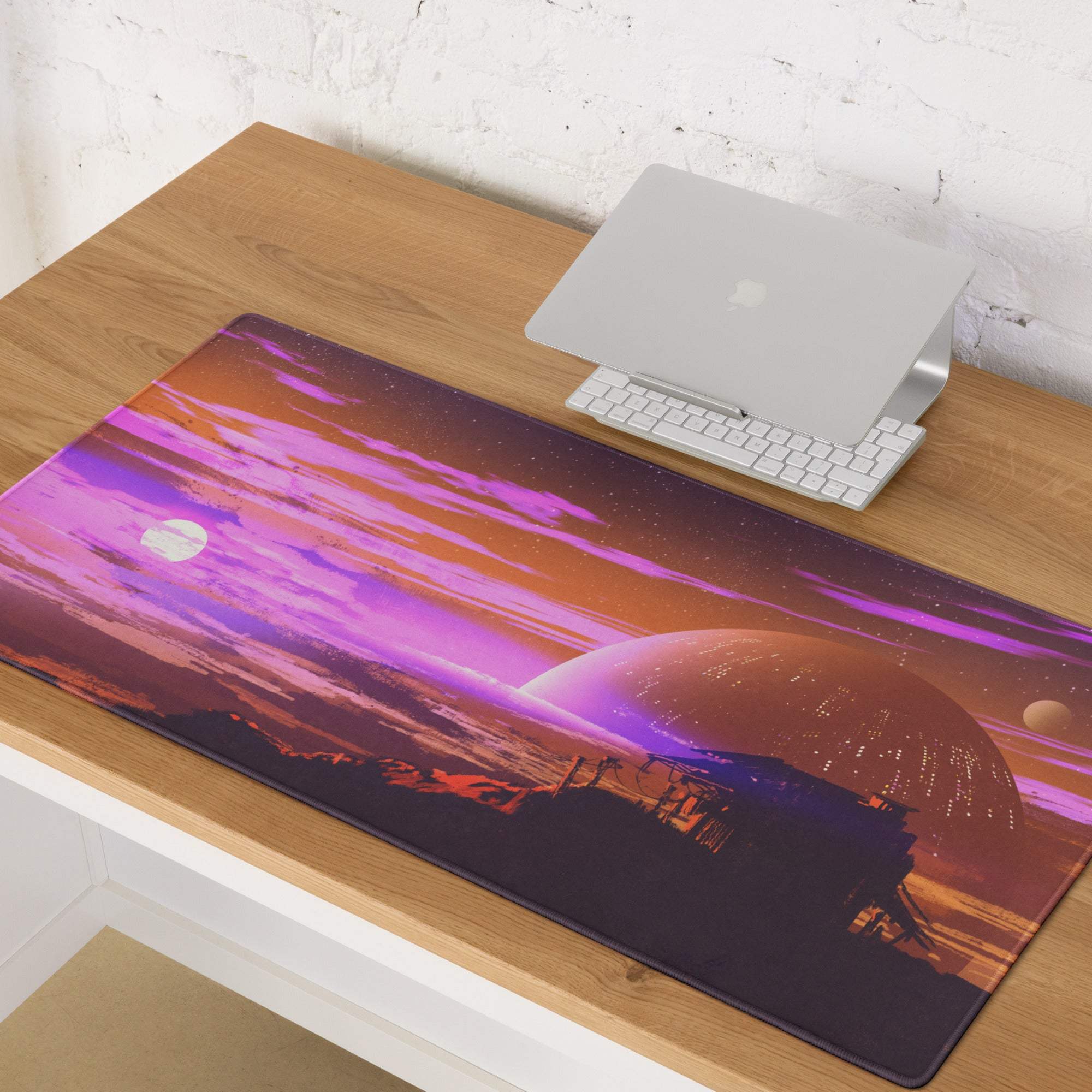 A rectangular vibrant purple and orange cosmic-themed gaming mousepad featuring planets and stars digital art