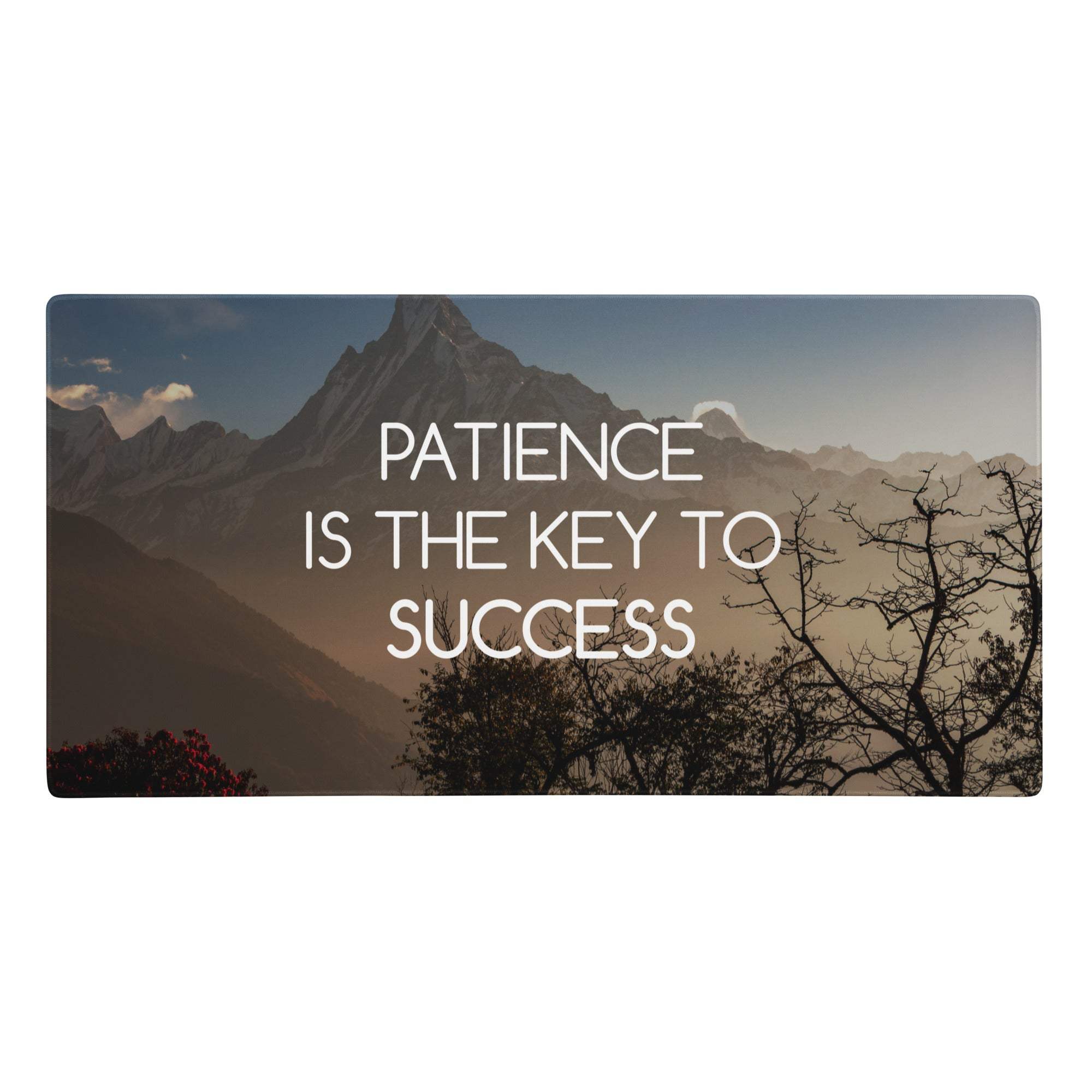 Rectangular blue sunset desk pad with mountain landscape and patience is the key to success white text for office use