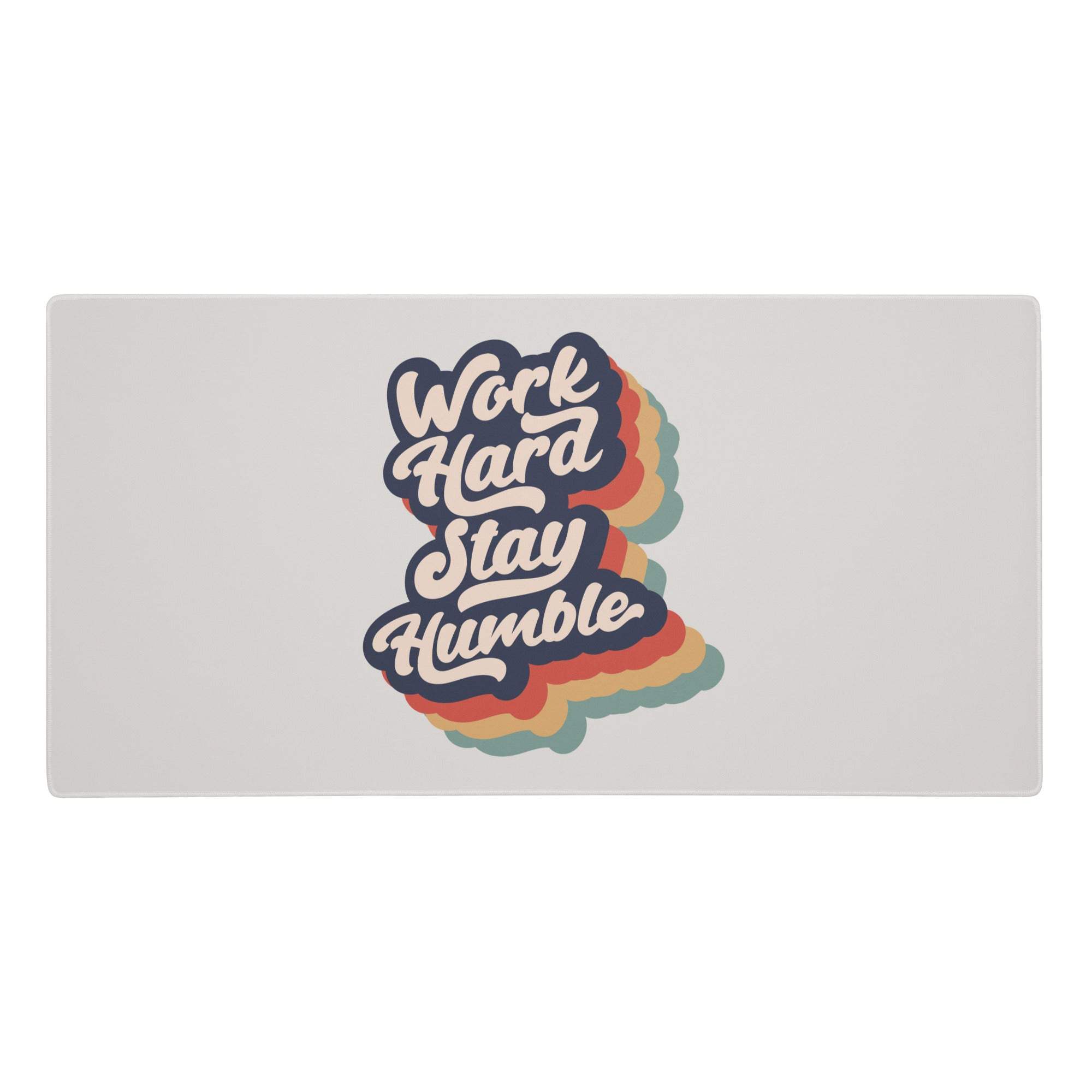 A gray rectangular fabric mousepad with the phrase work hard stay humble in rainbow outlines for modern office decor