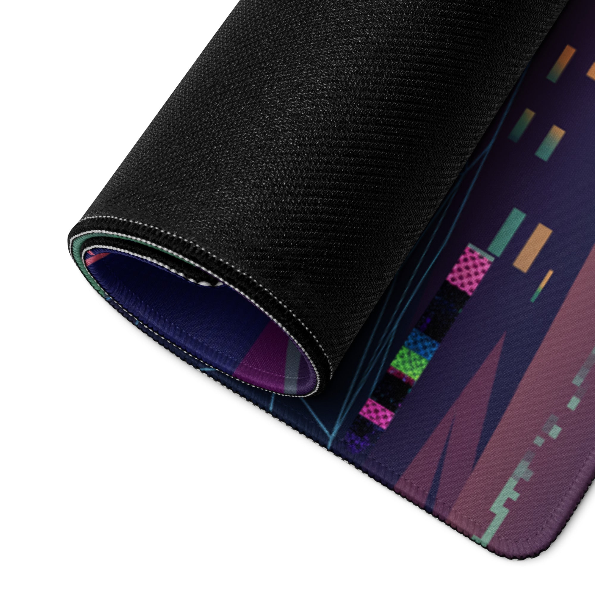 A rolled-up vaporwave neon gamer desk pad with a black textured surface and vibrant pink green blue orange and purple patterns