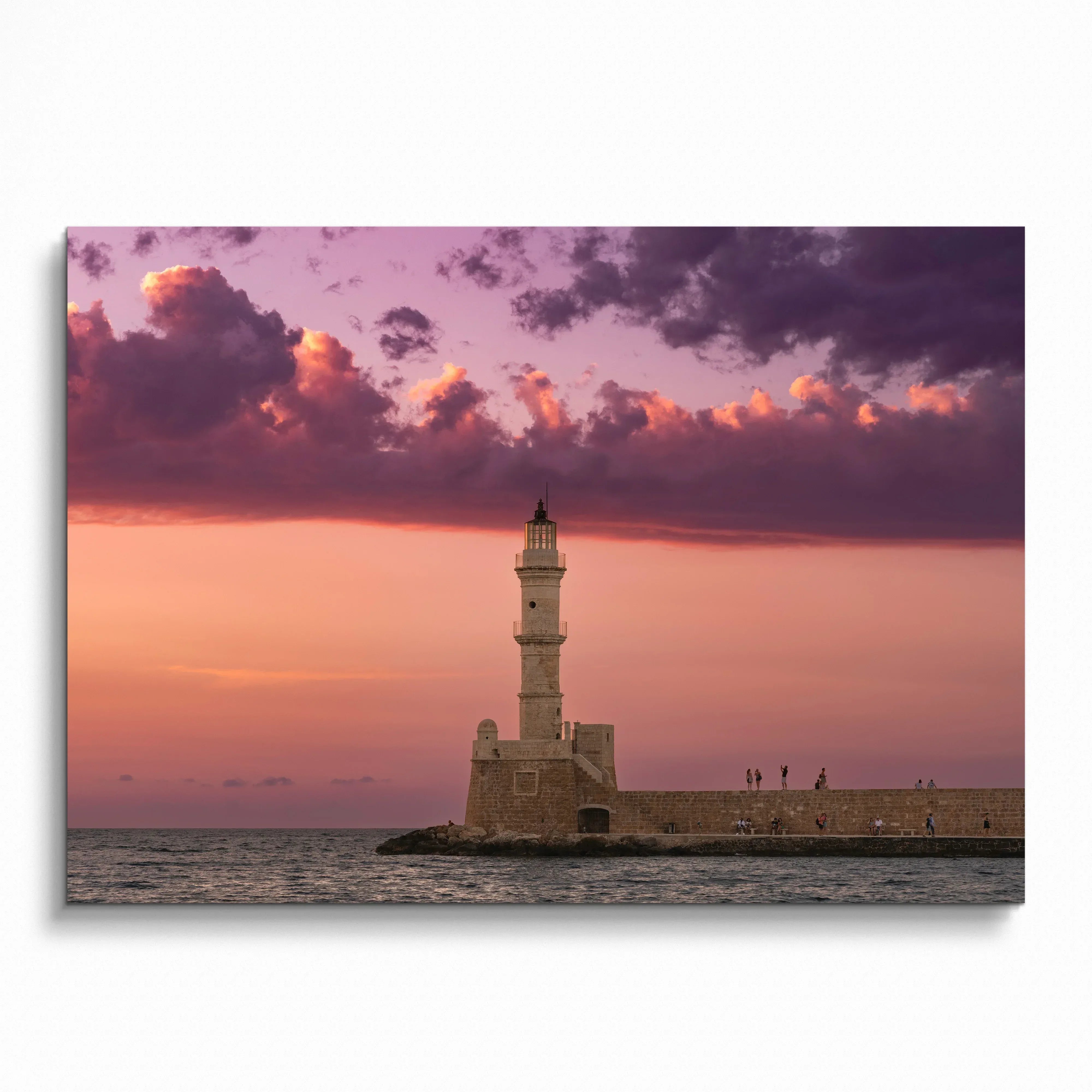 Sunset sky with purple and orange hues behind lighthouse on water wall art poster.