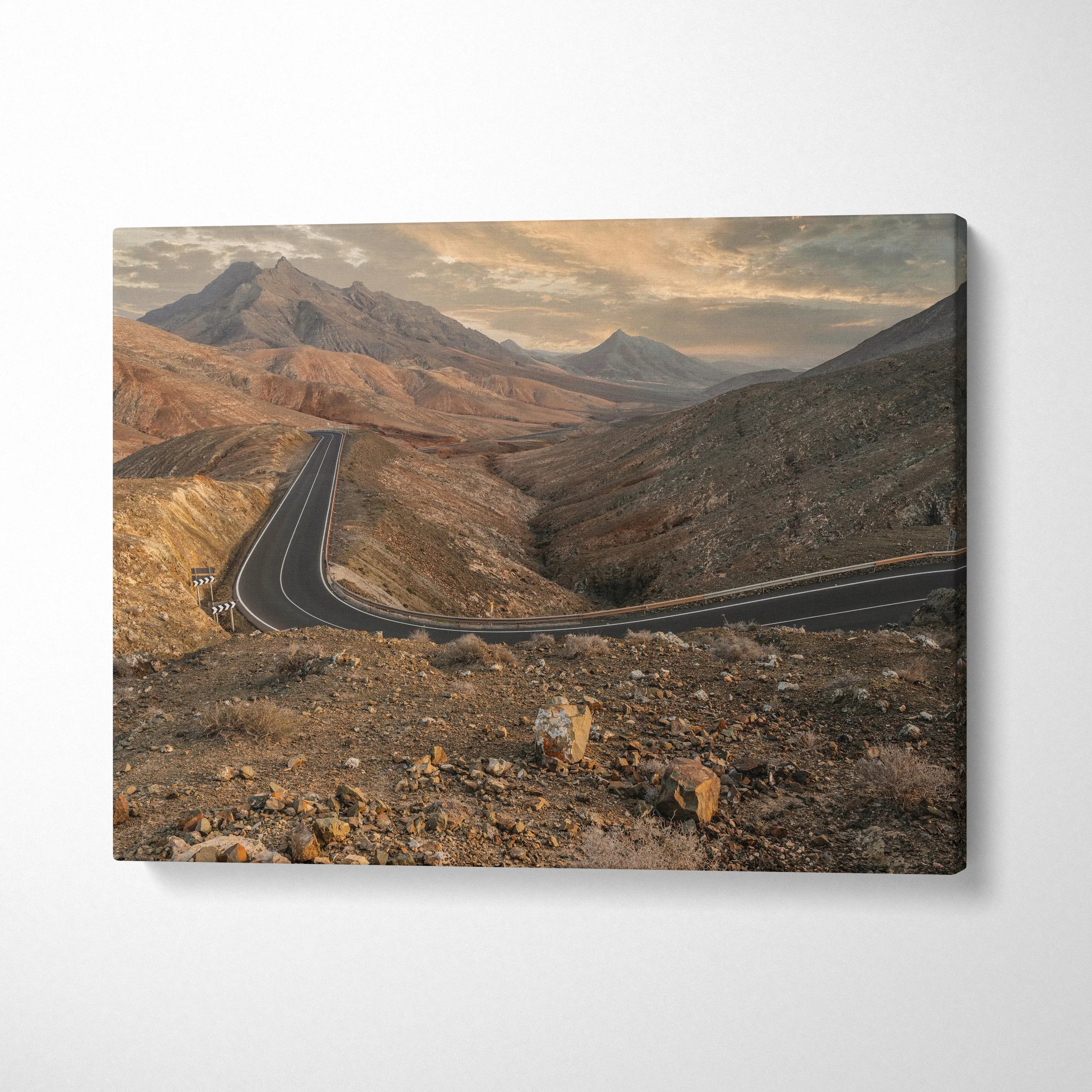 Desert mountain landscape canvas wall art with winding road under cloudy sky.