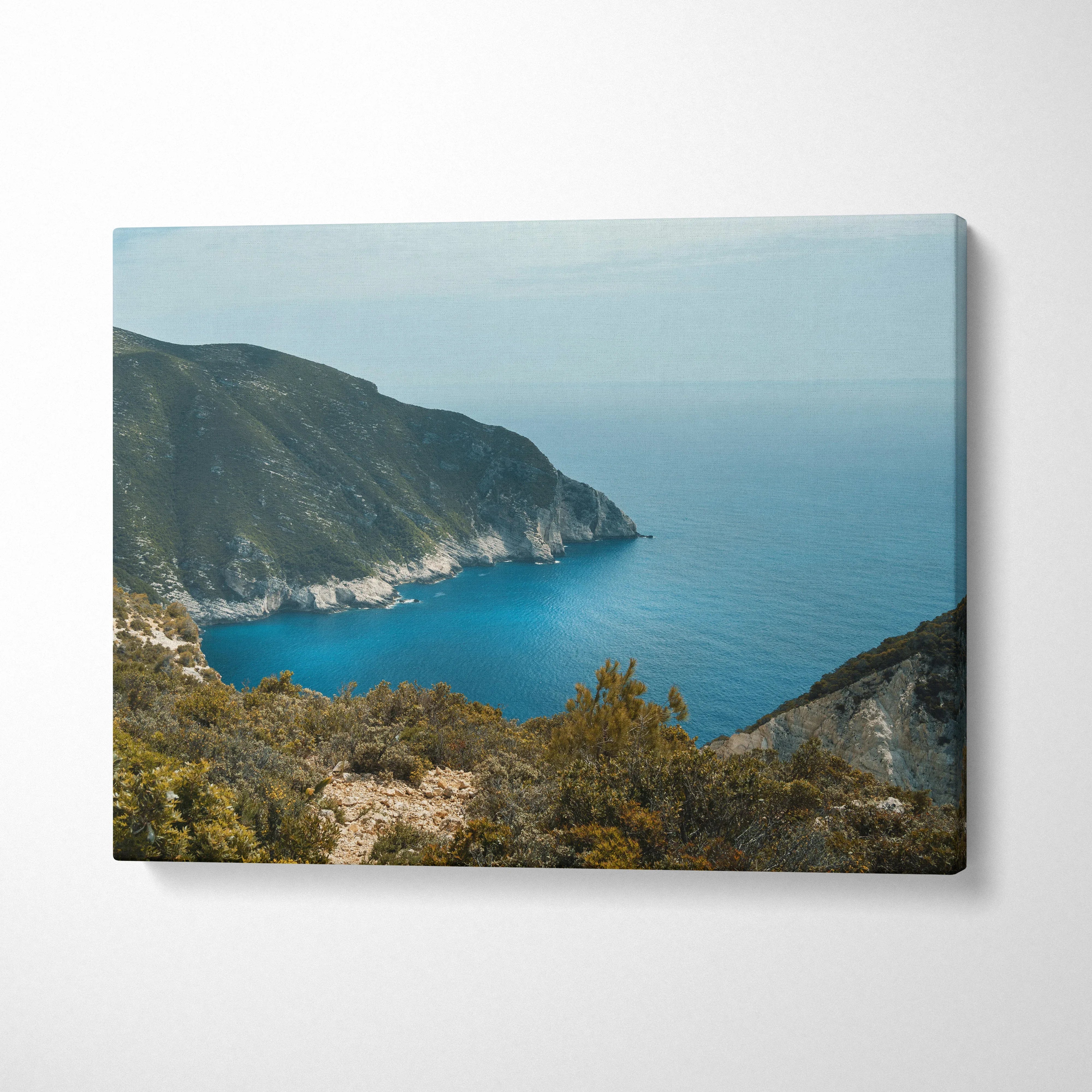 Mountain and ocean landscape canvas wall art with rocky cliffs and calm blue water.