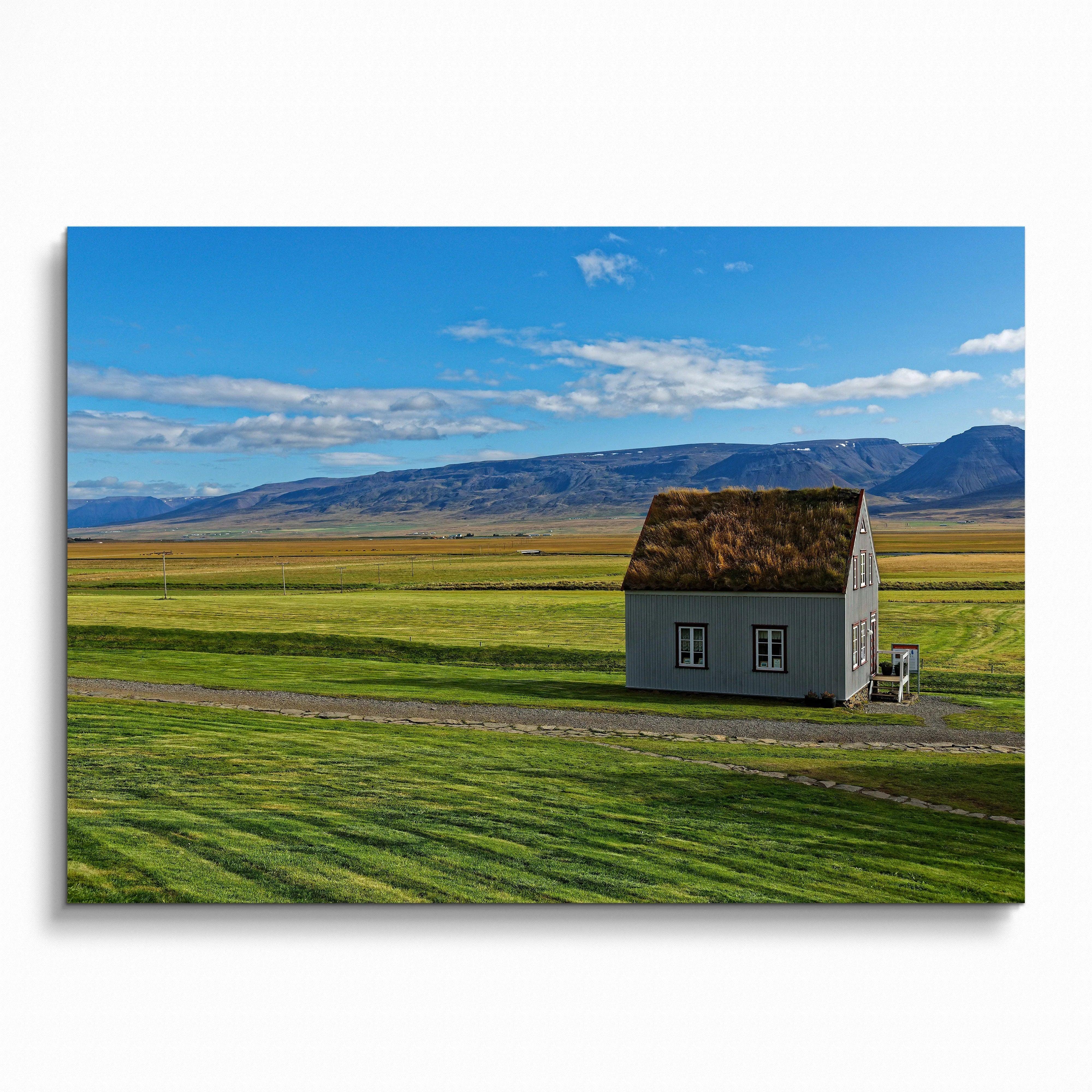 Modern architectural building poster featuring a small house in a green field under blue sky wall art.