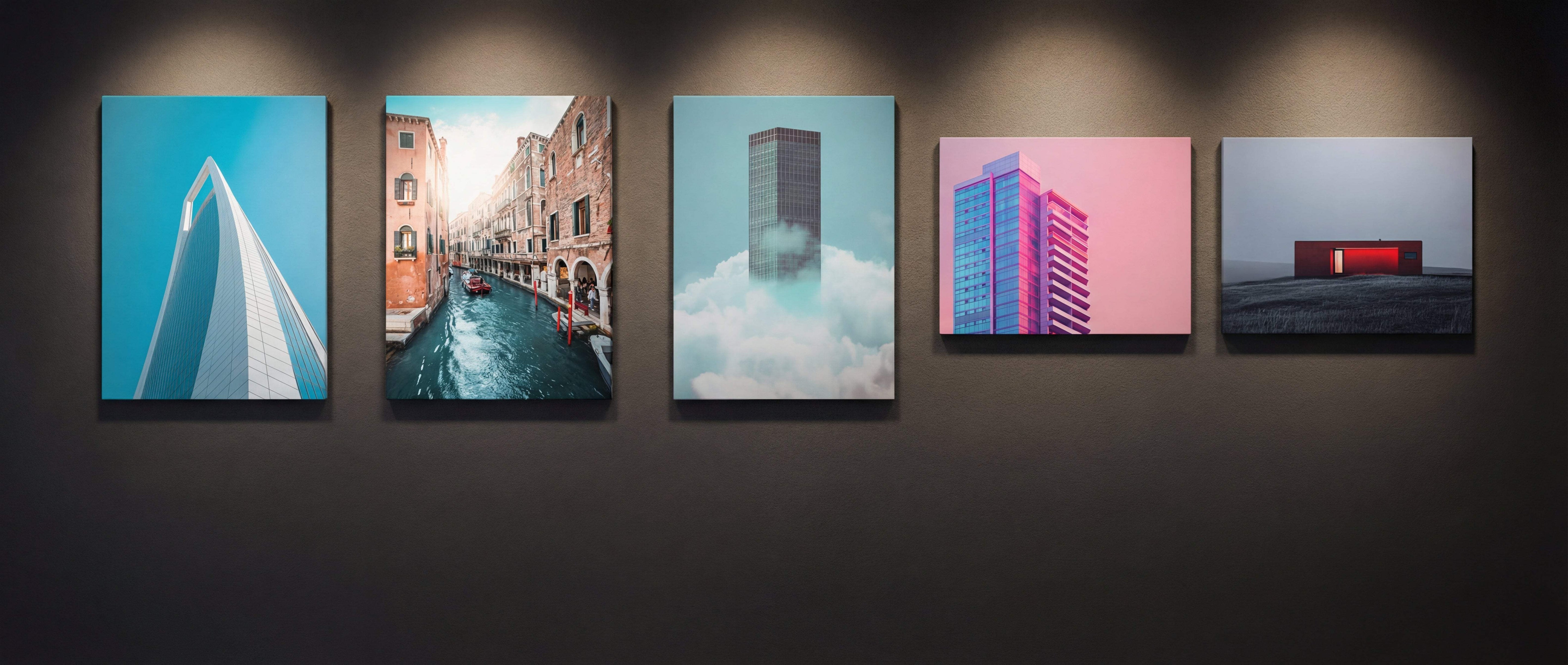 Five framed cityscape prints hang on a dark wall, each showcasing distinct architectural scenes in vibrant colors.