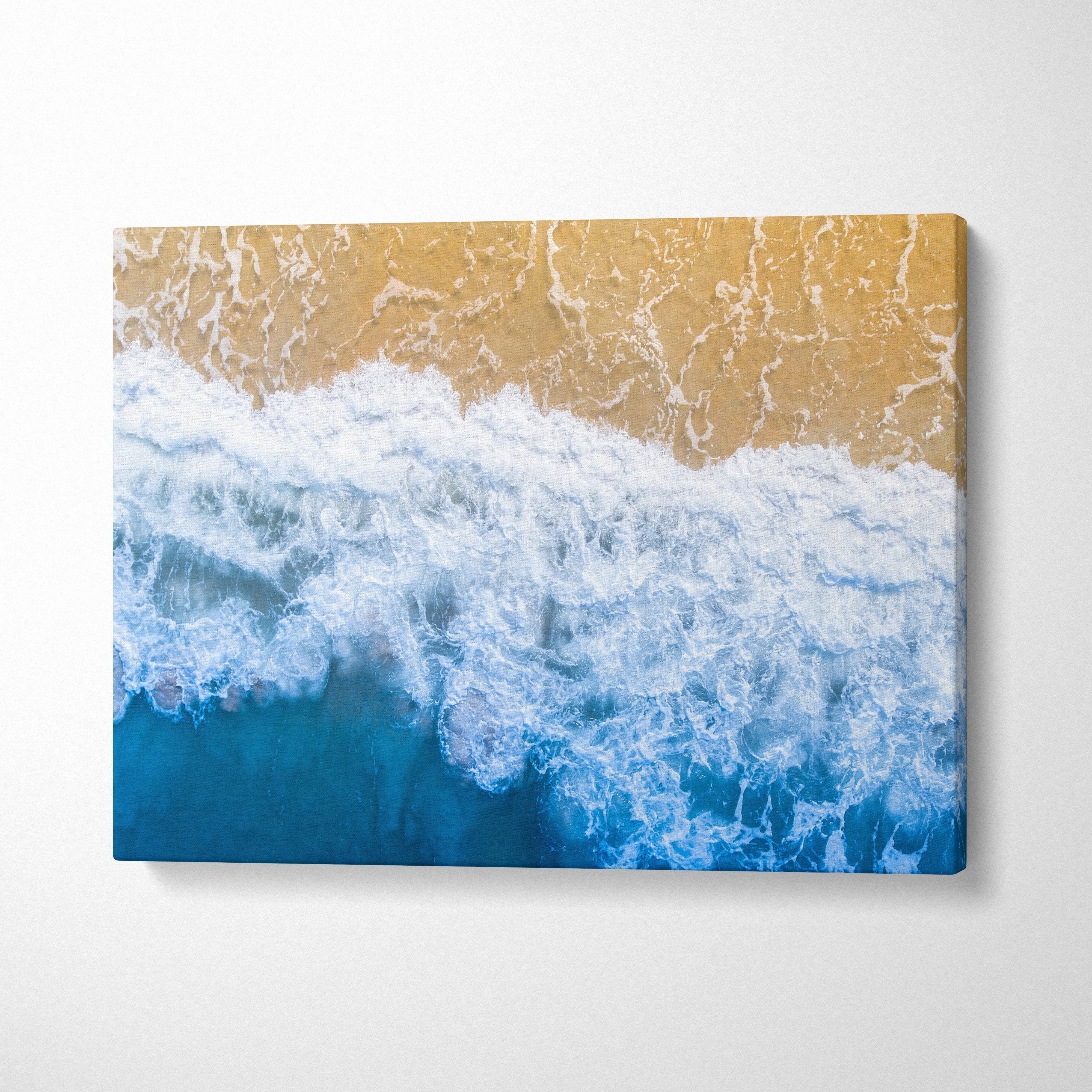 Aerial ocean shore rectangular canvas print featuring vivid blue waves crashing on golden sand for coastal decor