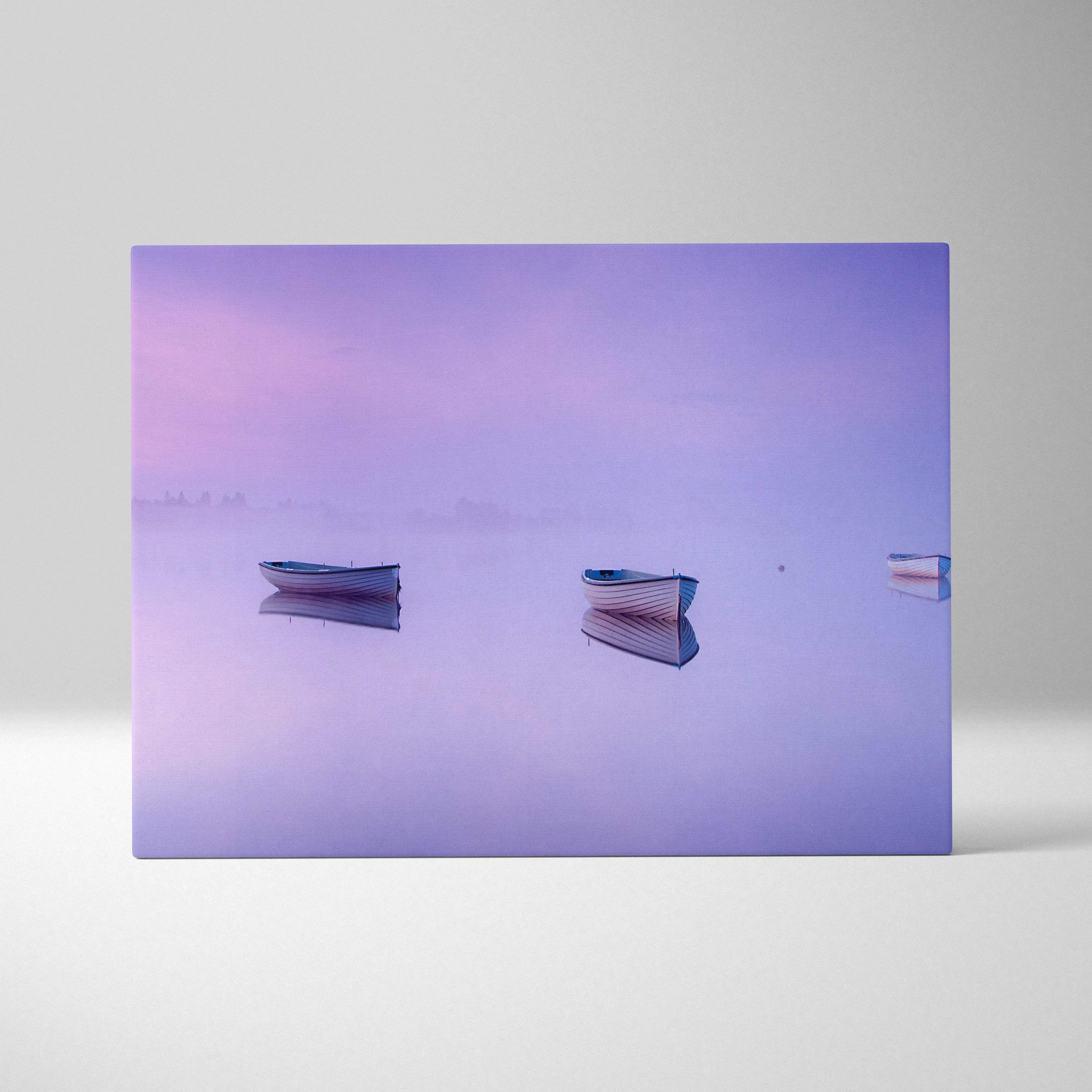 Purple-hued canvas print of three boats on foggy mirror lake in lilac pink blue tones