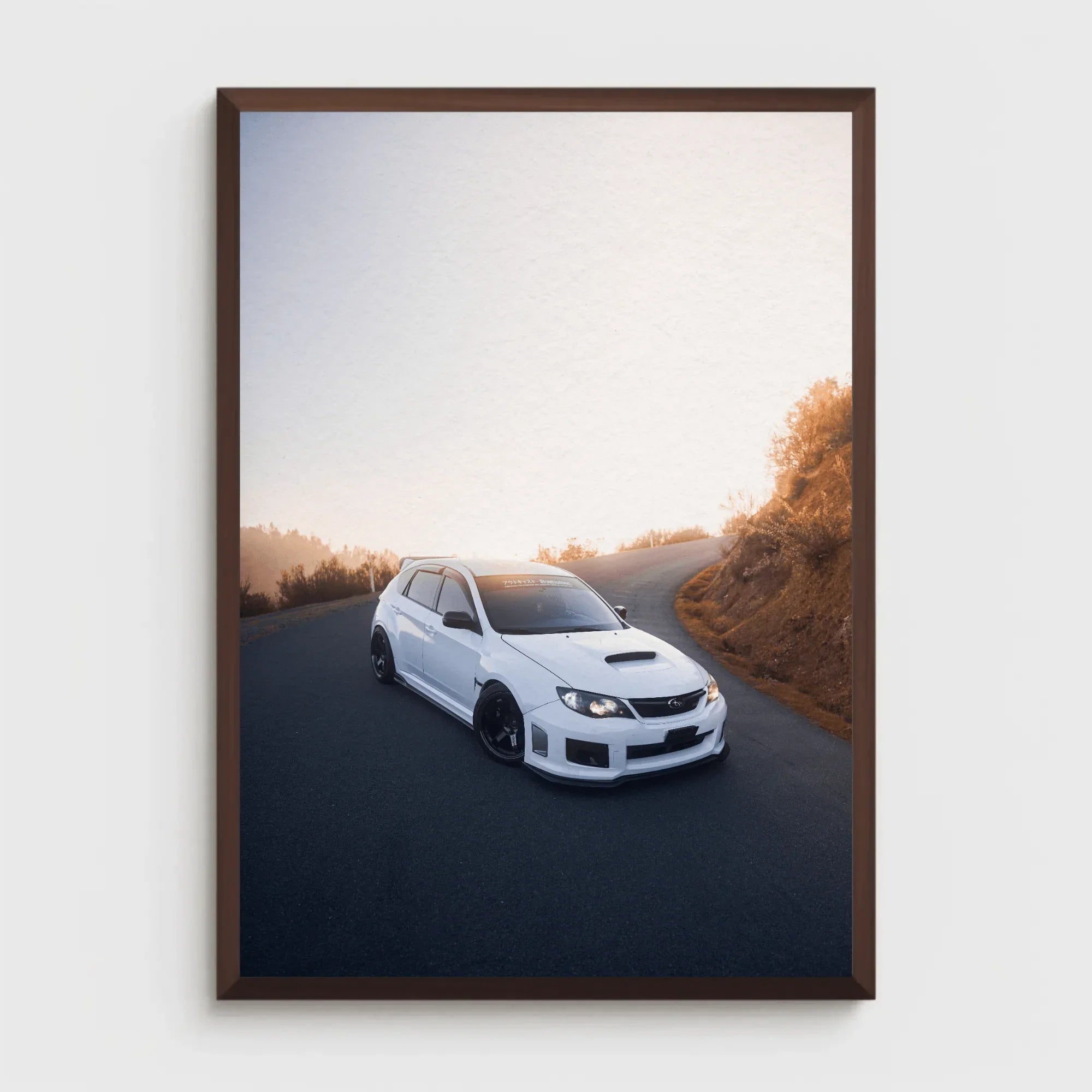Subaru WRX STI poster with white car on winding road at sunset, framed wall art.