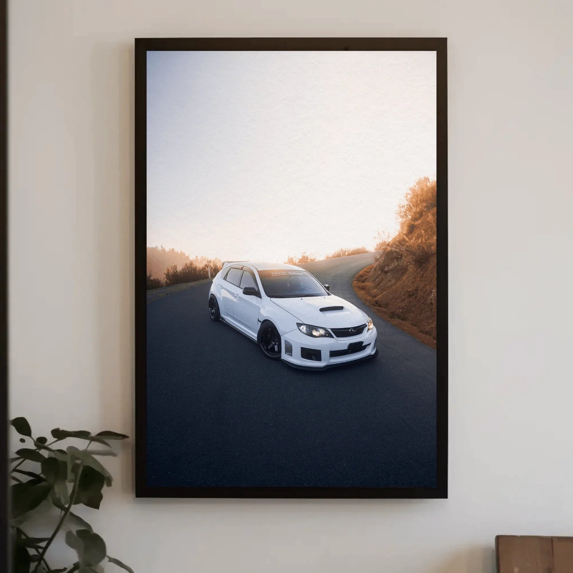 Subaru WRX STI poster featuring white car on winding road at sunset, framed wall art.