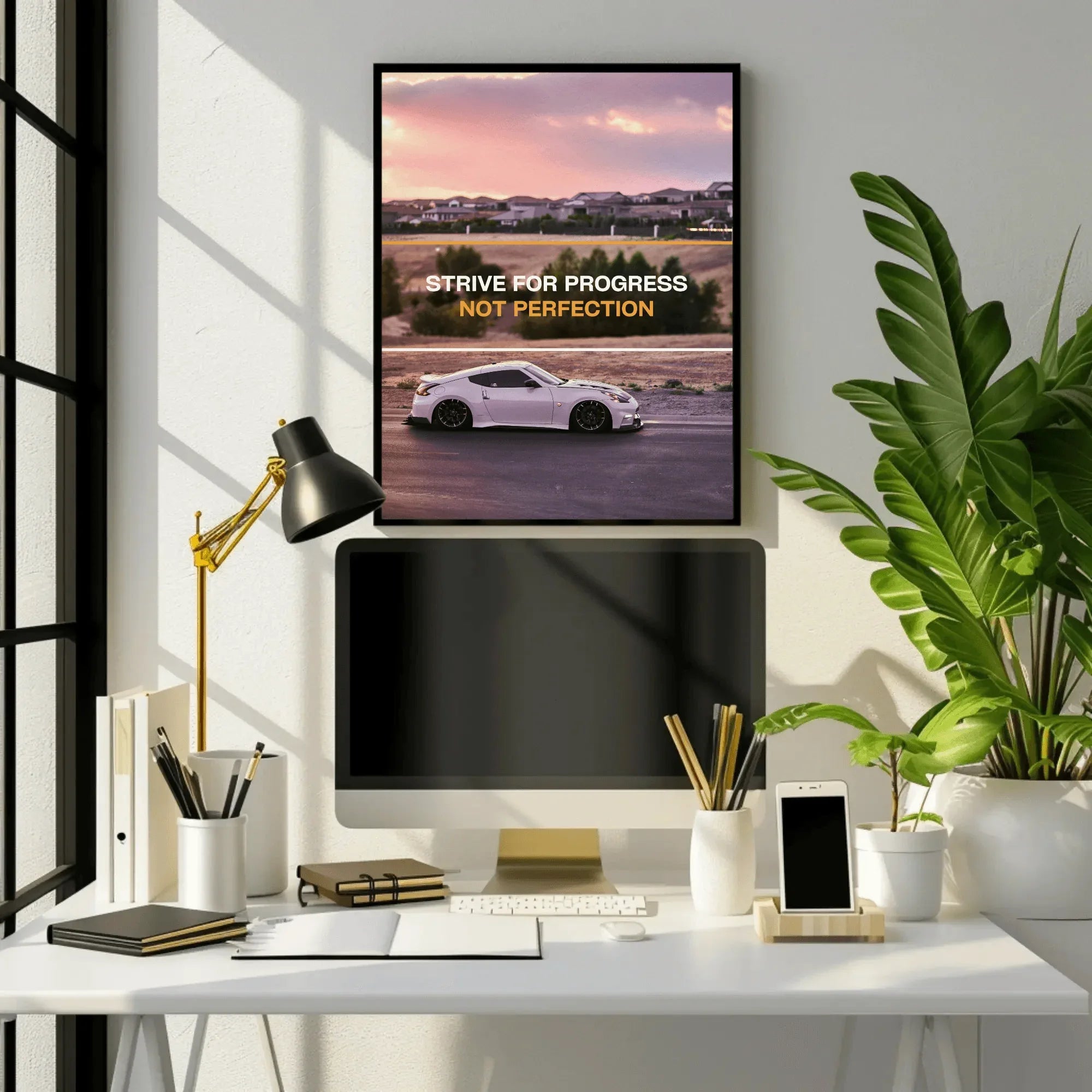Motivational poster wall art with white Nissan 370z and "Strive for progress not perfection" text in black frame.
