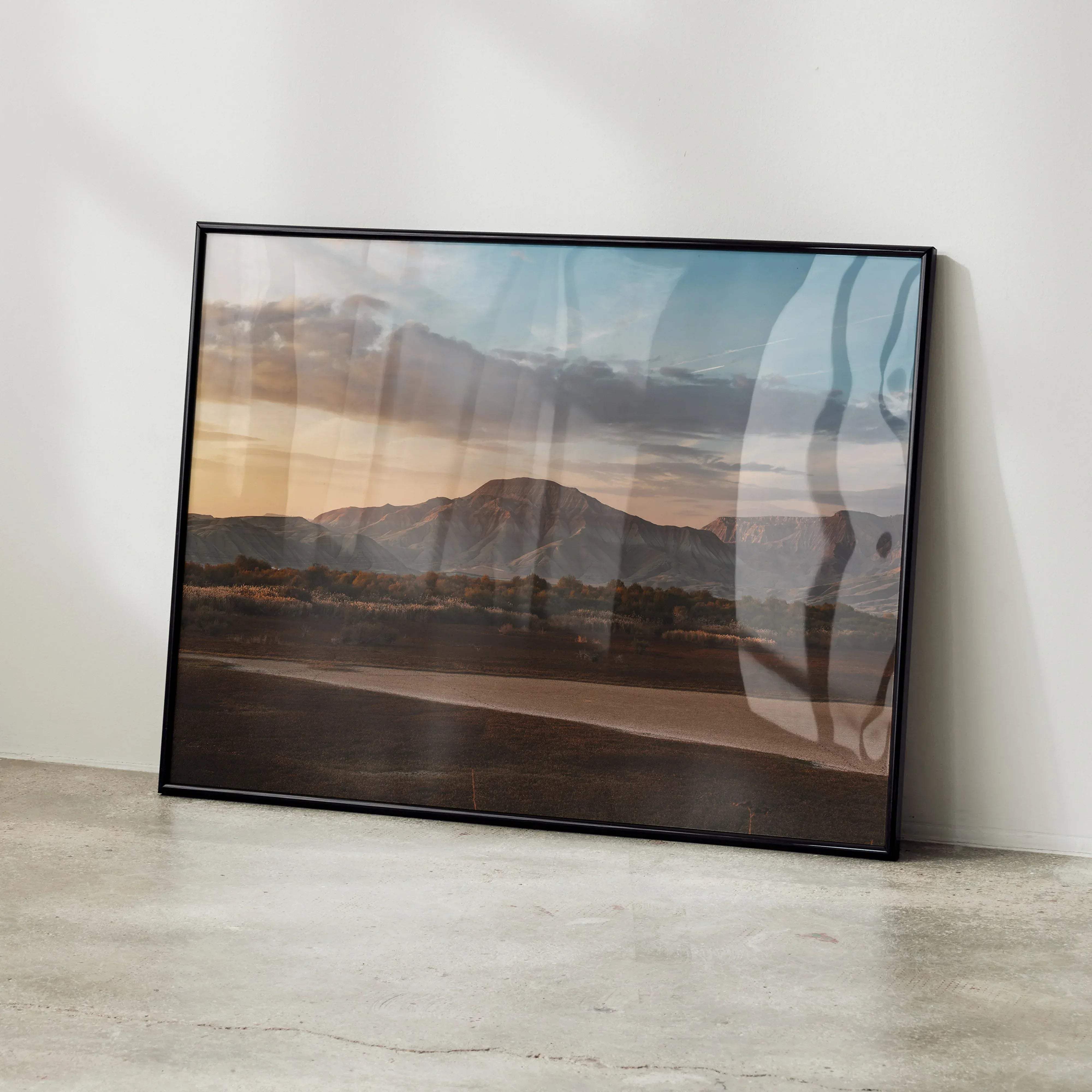Black-framed majestic mountain wall art poster featuring a landscape of mountains and sunset sky for home decor