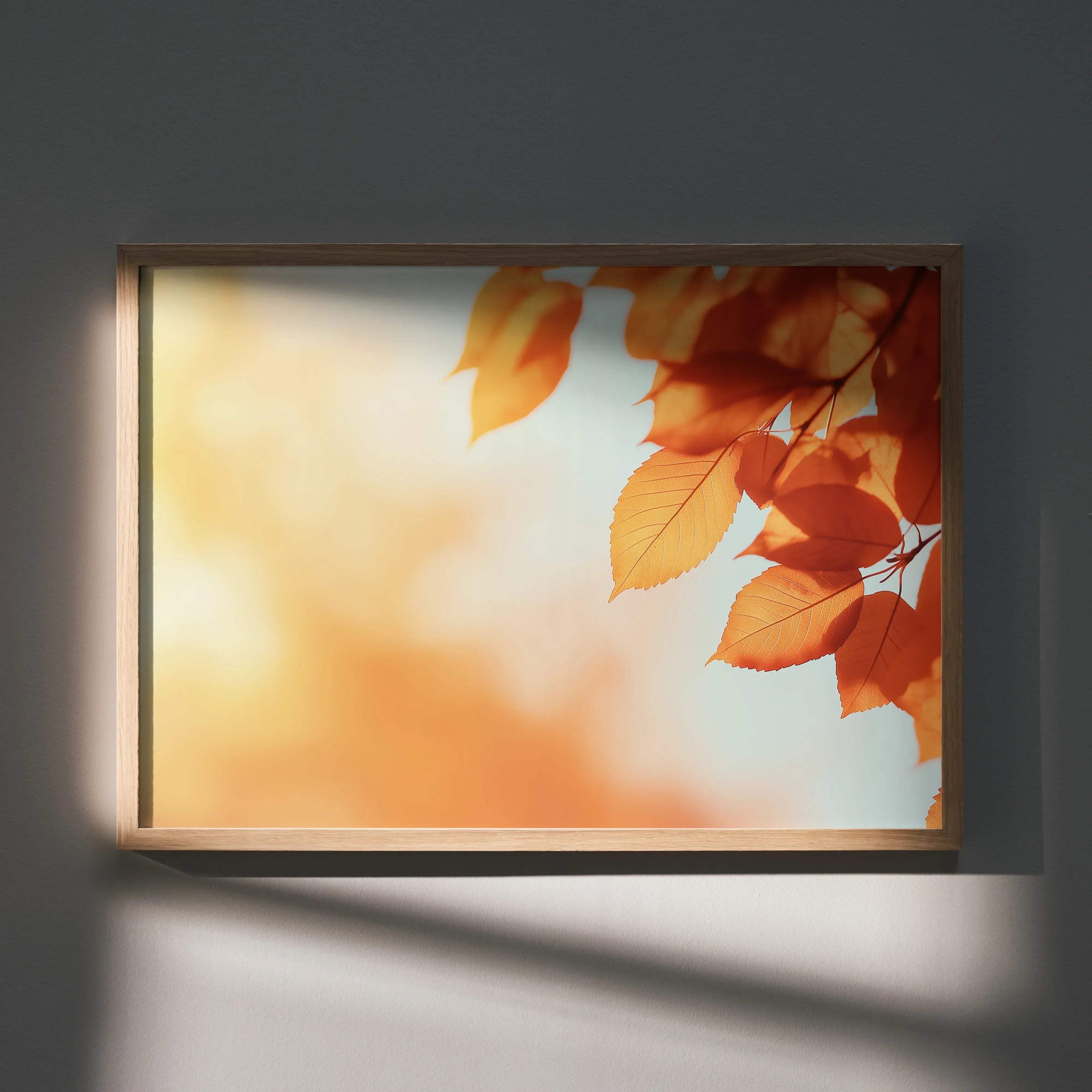 A rectangular framed digital art poster featuring vibrant orange and yellow autumn leaves against a soft blurred sky background