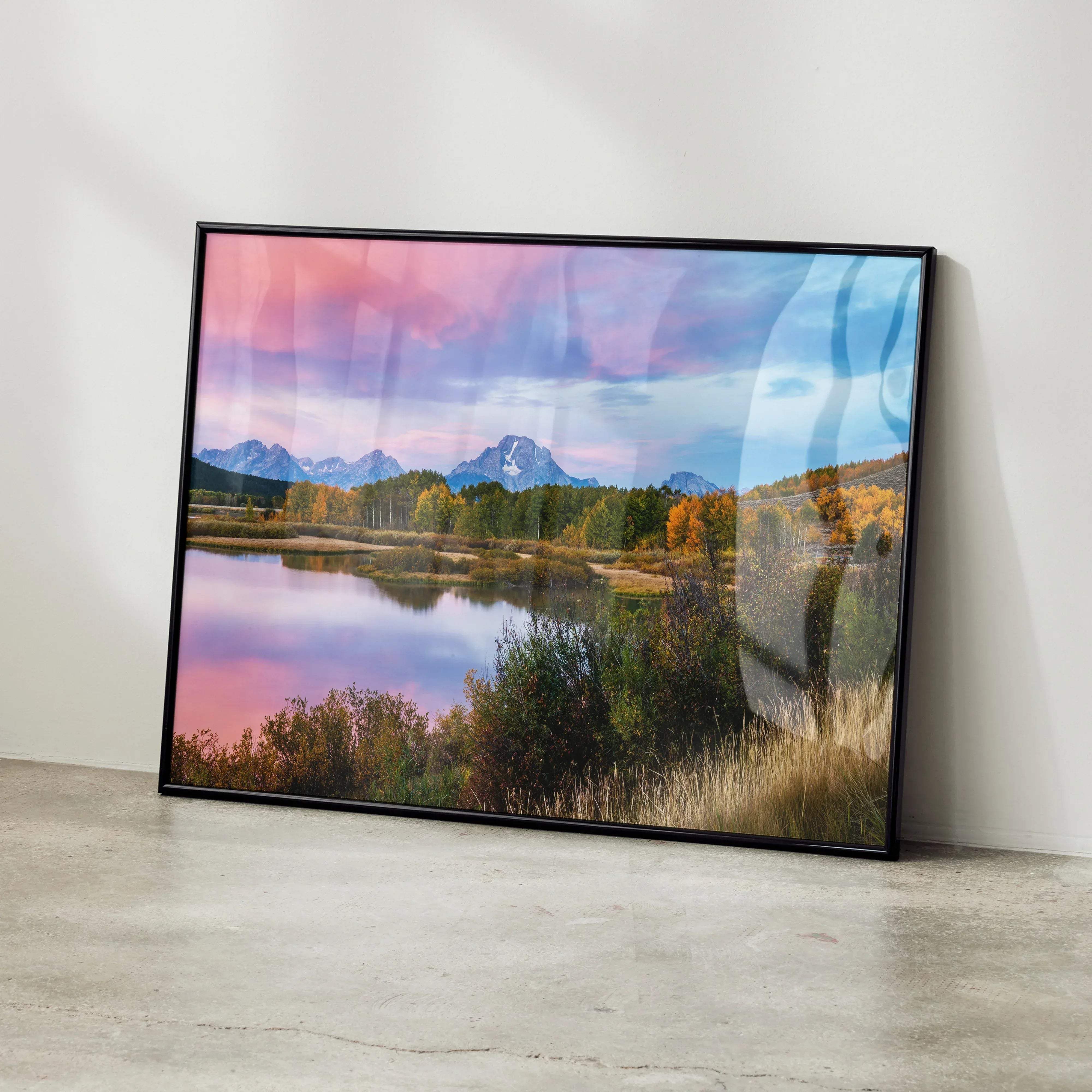 Black-framed landscape print of a serene mountain lake at sunset with vibrant pink purple skies and autumn trees wall art