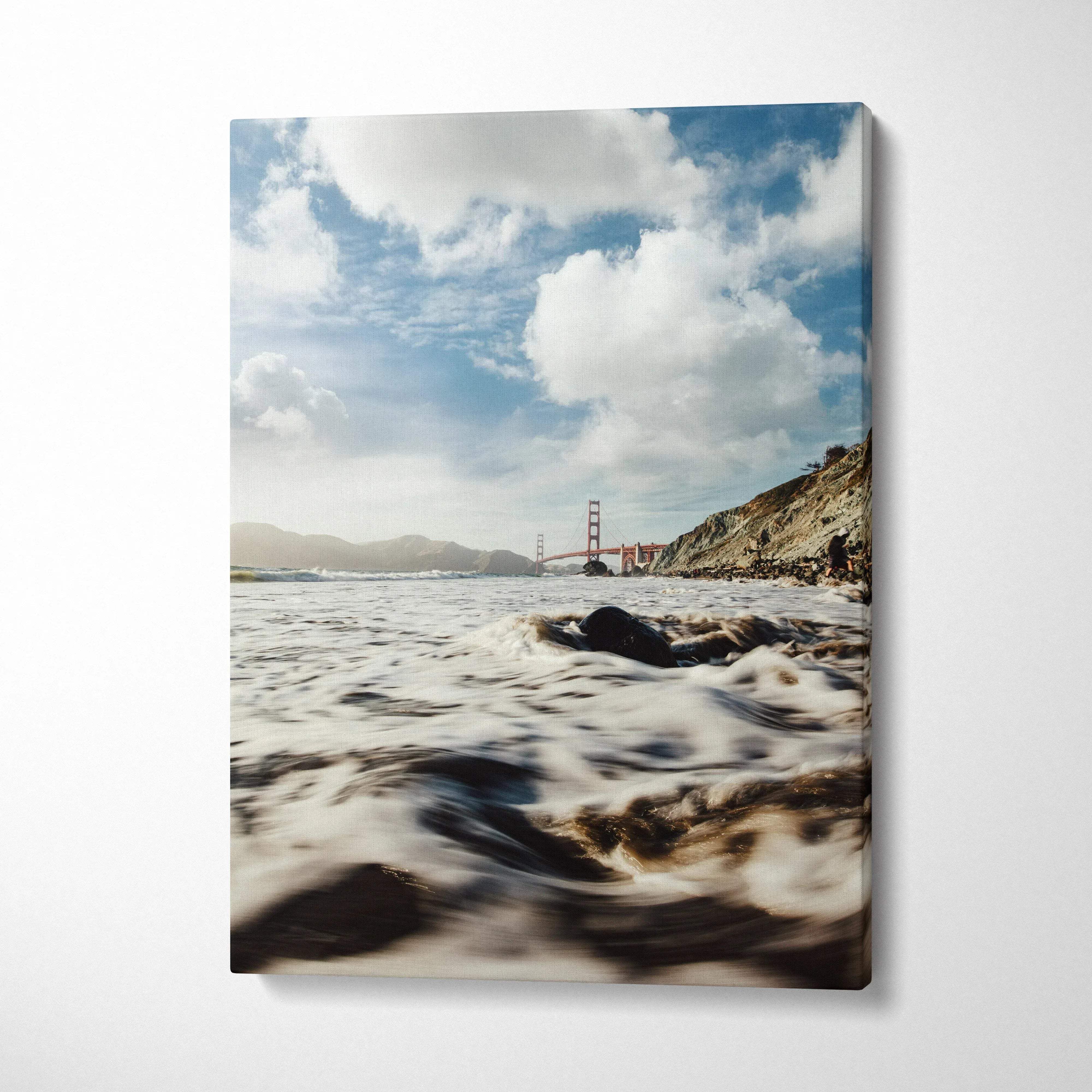 Canvas wall art featuring a serene beach scene with waves and the Golden Gate Bridge in the background.