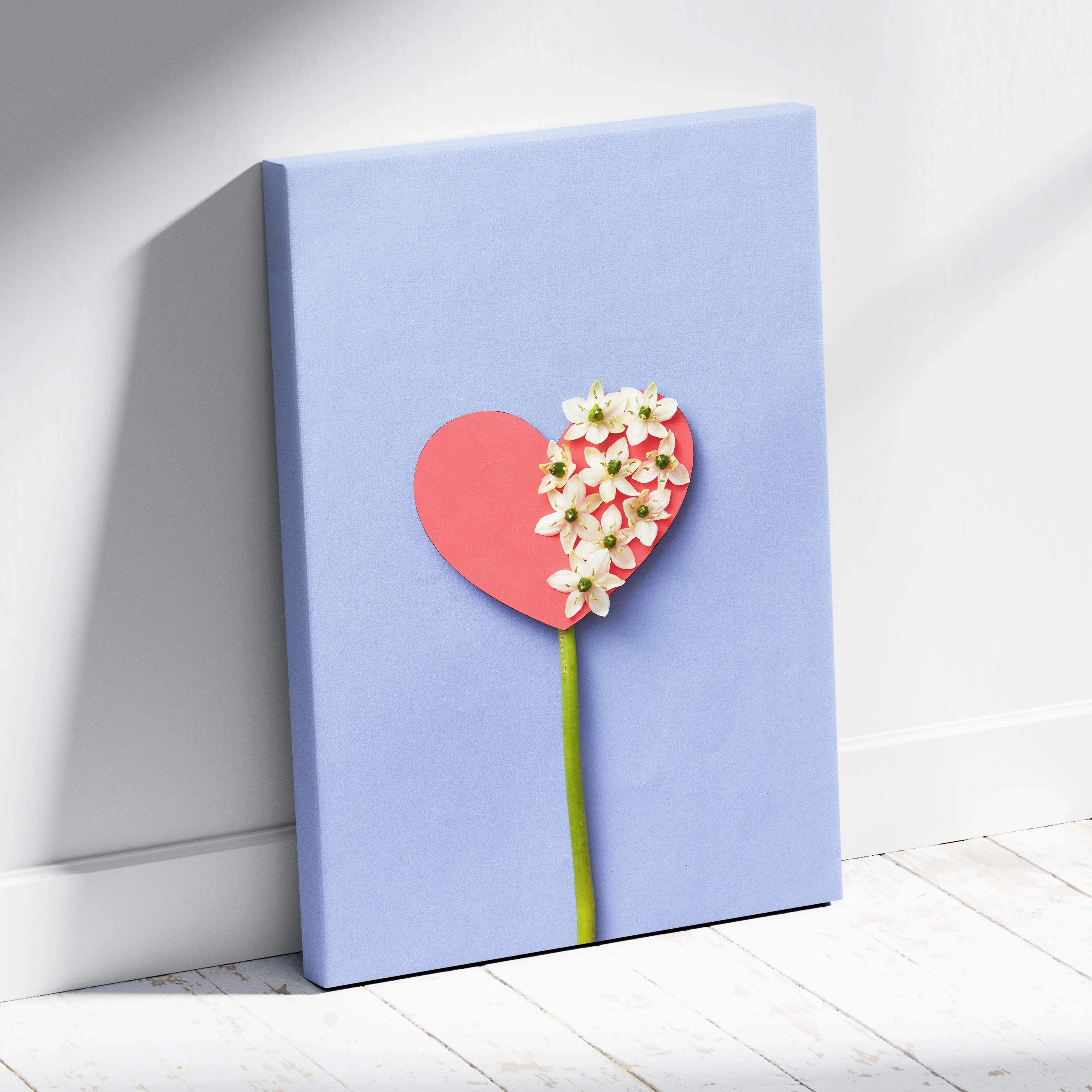 Pastel blue heart canvas wall art with pink heart flower, white blossoms, green stem