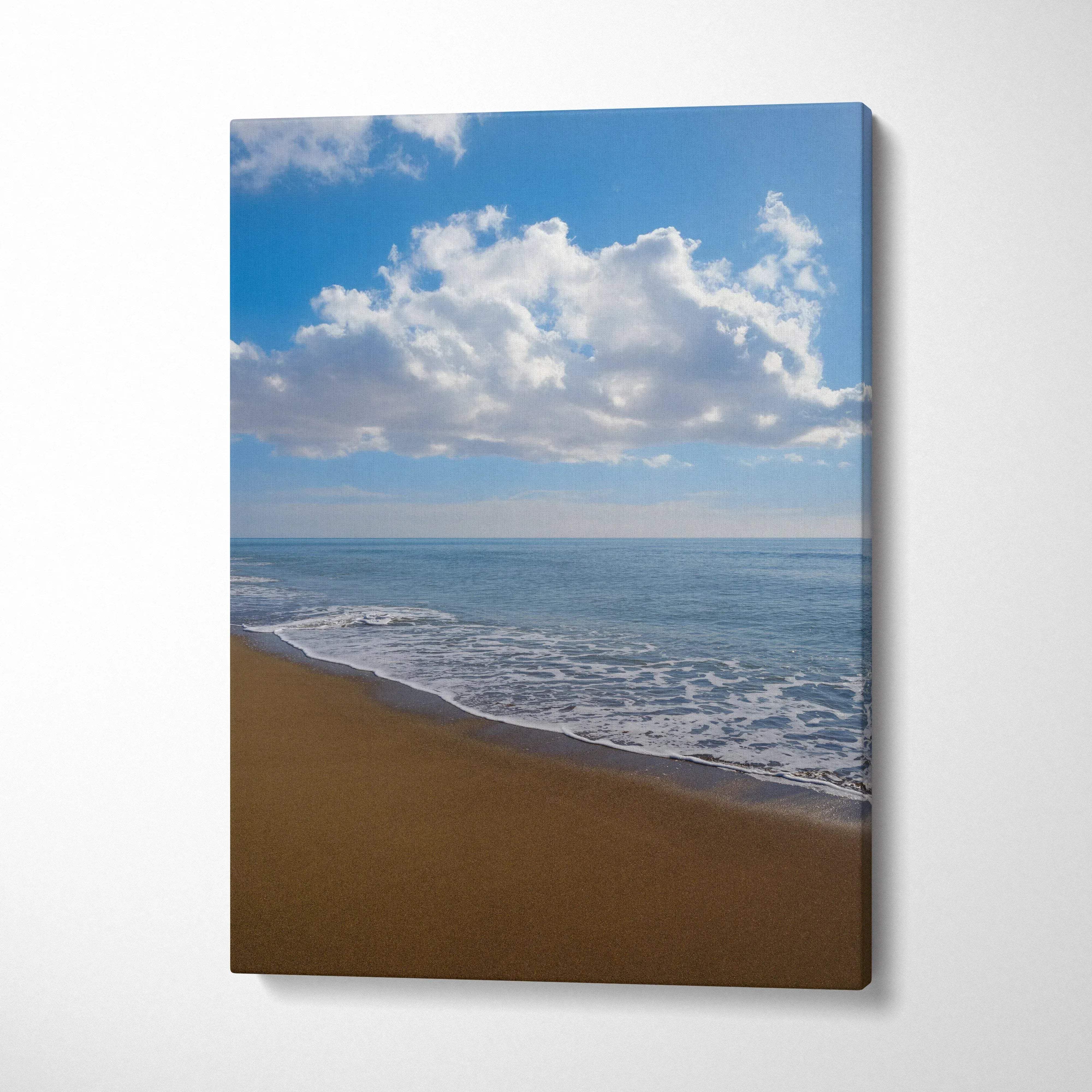 Serene beach landscape canvas wall art with sandy shore, gentle waves, and blue sky with clouds.