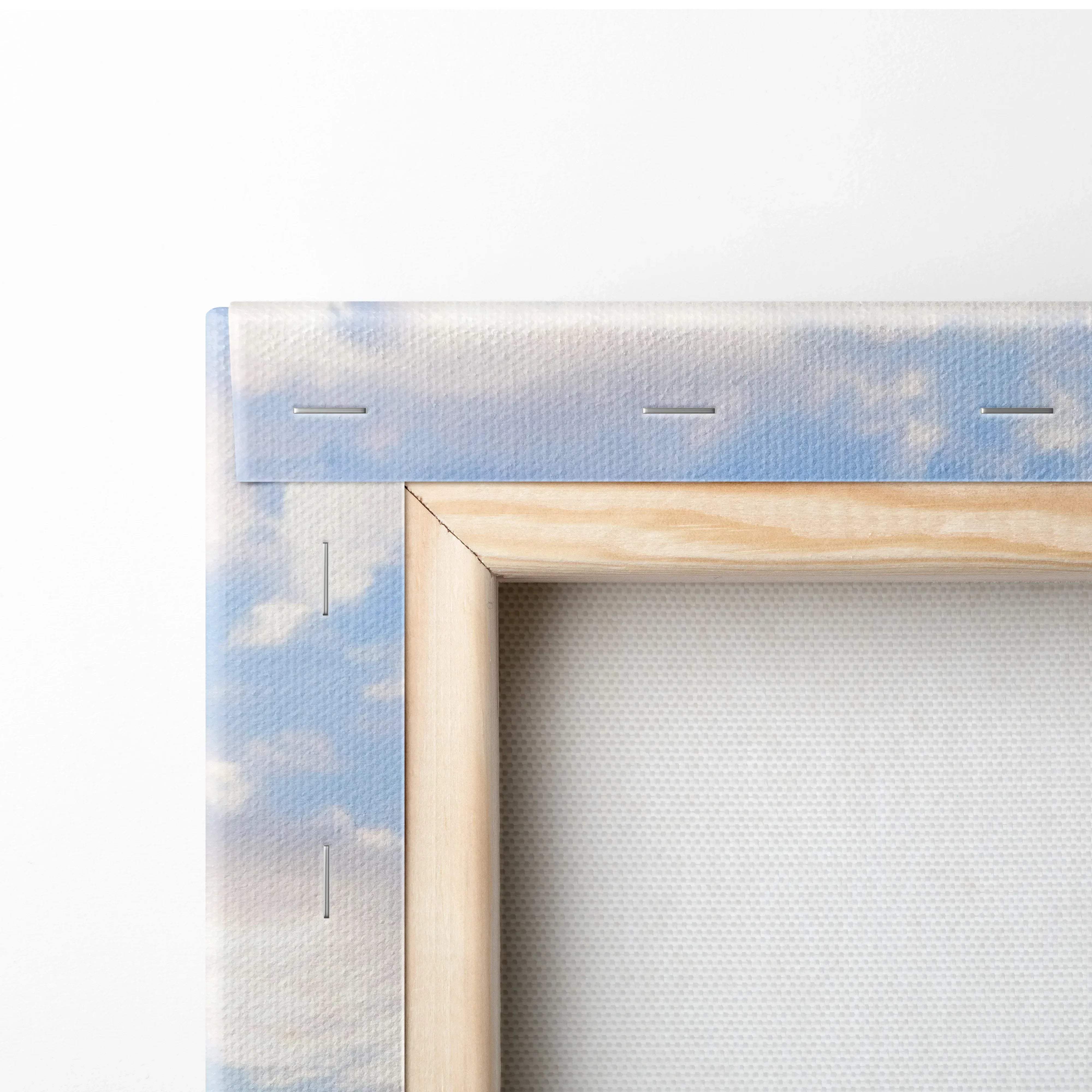 Light wood framed canvas wall art with serene ocean sunset featuring tranquil blues and soft pink sky at dusk