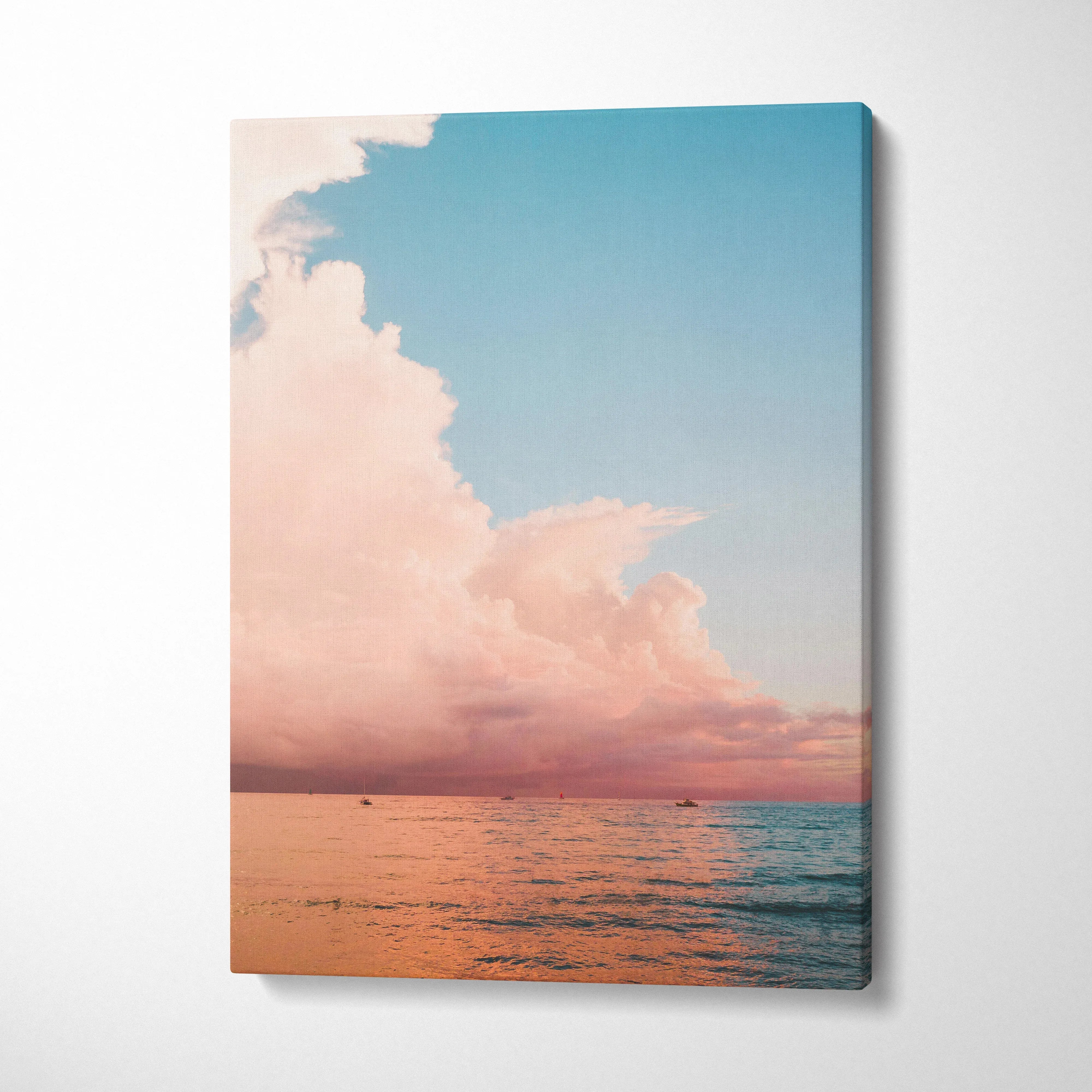 Canvas wall art featuring a pink and blue ocean sunset with soft clouds over calm water.