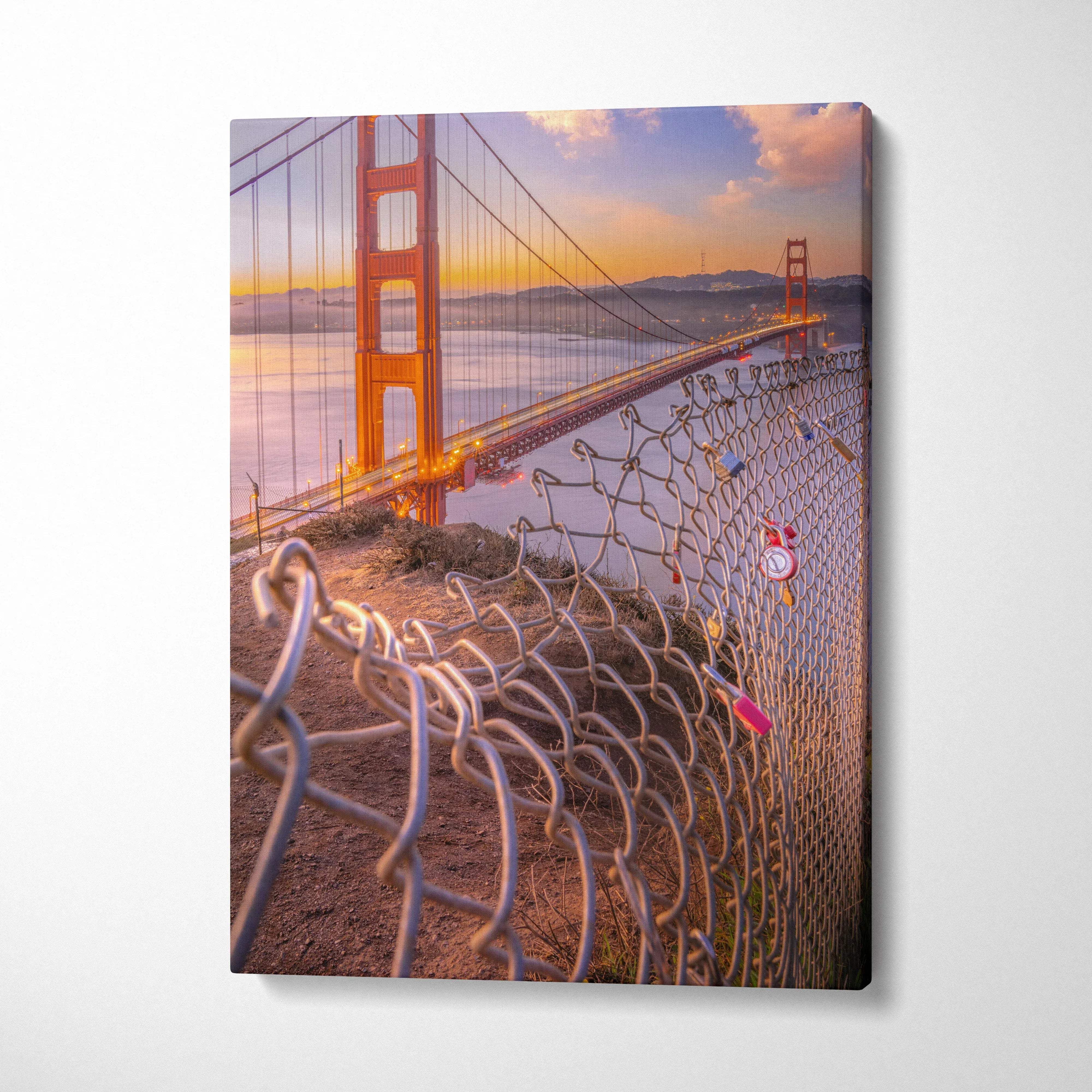 Golden Gate Bridge at sunset with curved chain link fence in foreground canvas wall art.