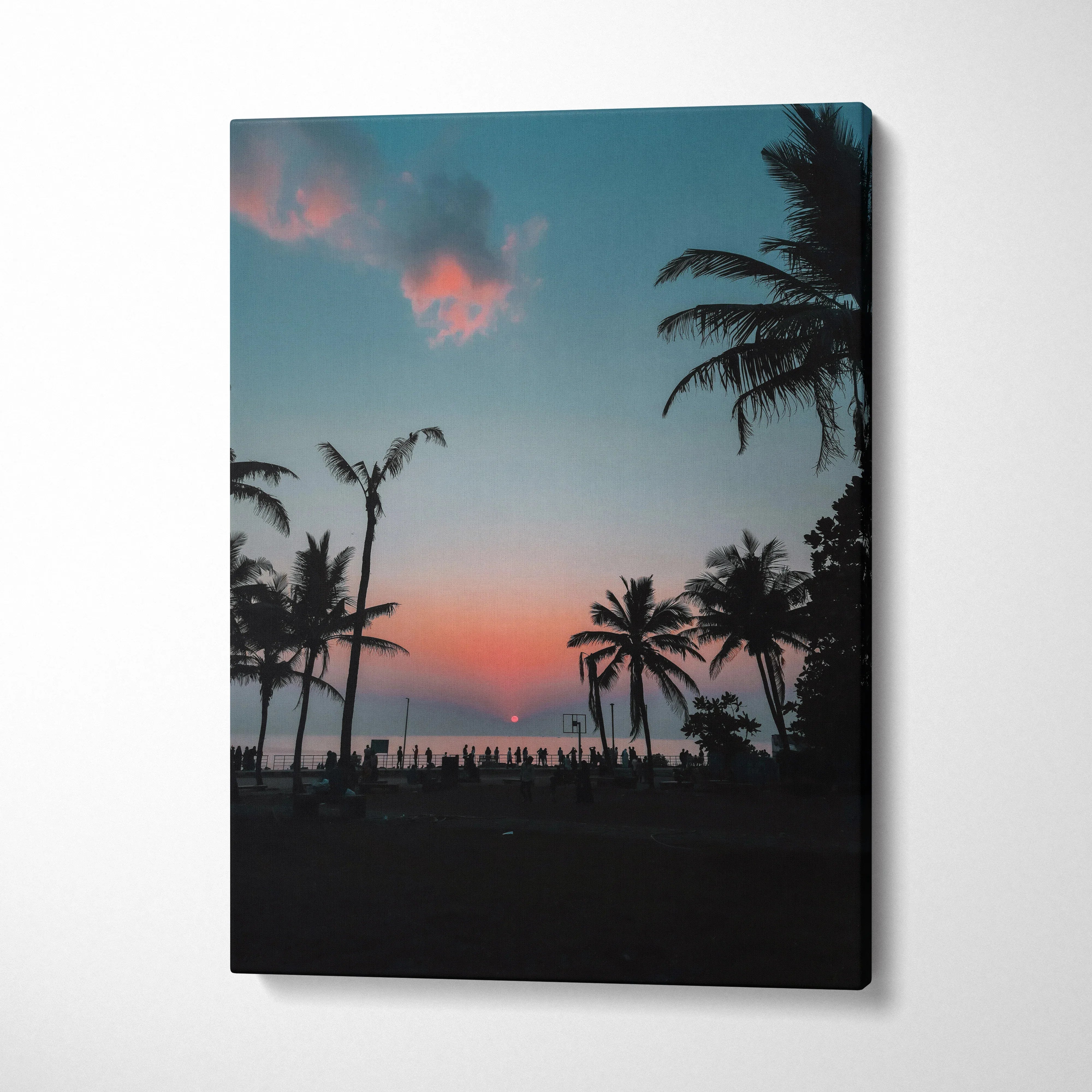 Ocean sunset beach scene with palm trees silhouetted on vertical canvas wall art.