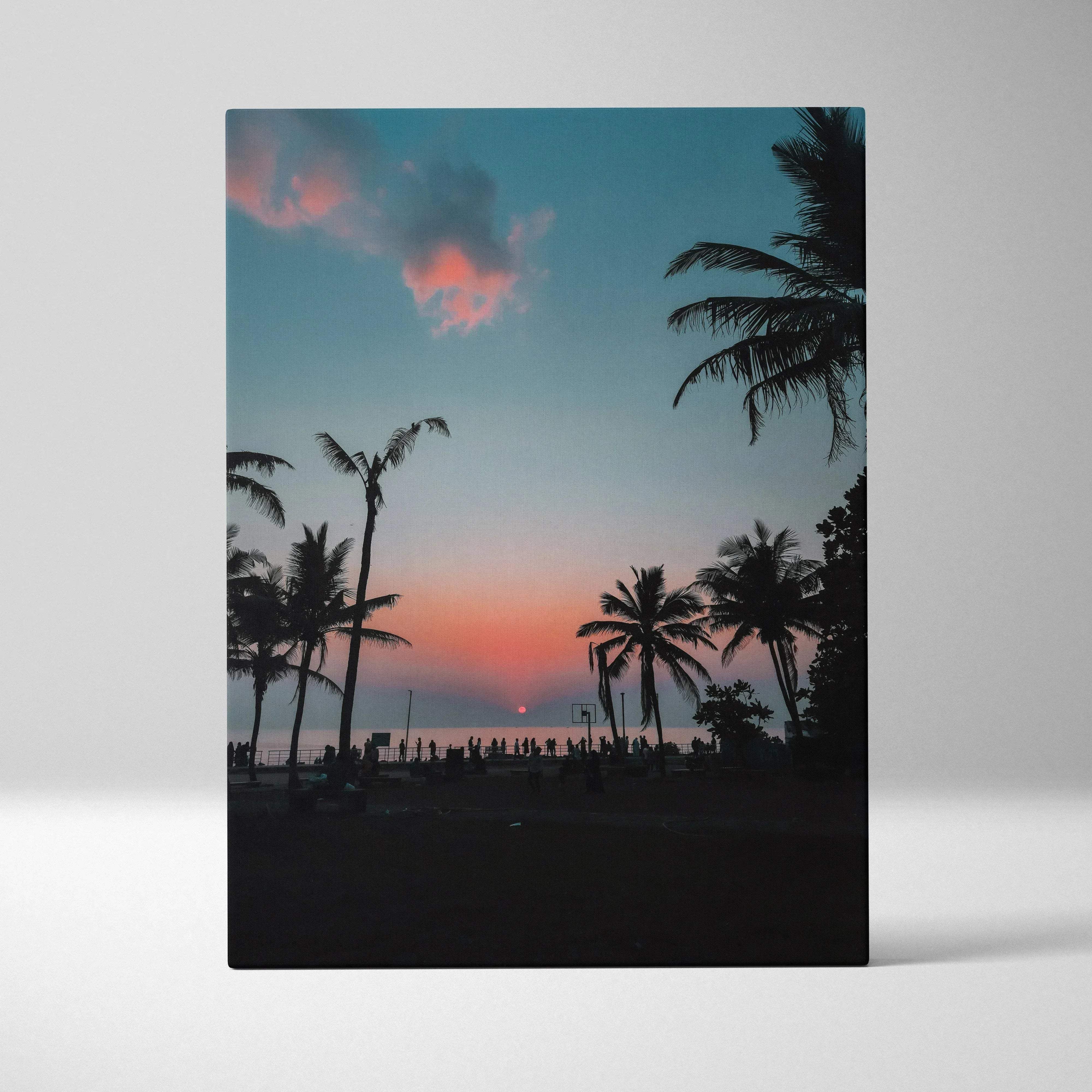 A rectangular canvas print of palm tree silhouettes against a vibrant pink and teal sunset sky for wall decor