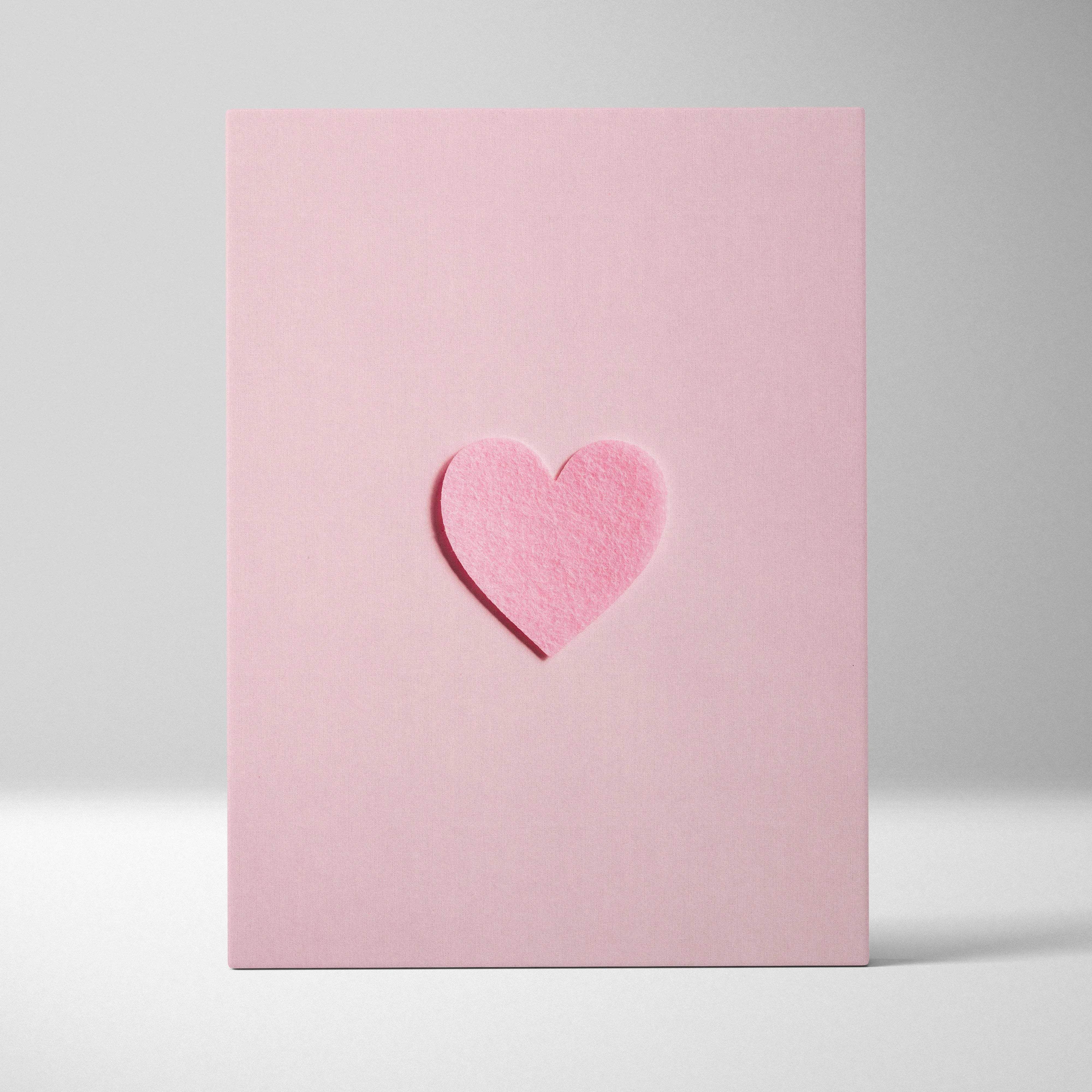 Minimal pink felt heart embossed on pastel pink canvas wall art flat lay
