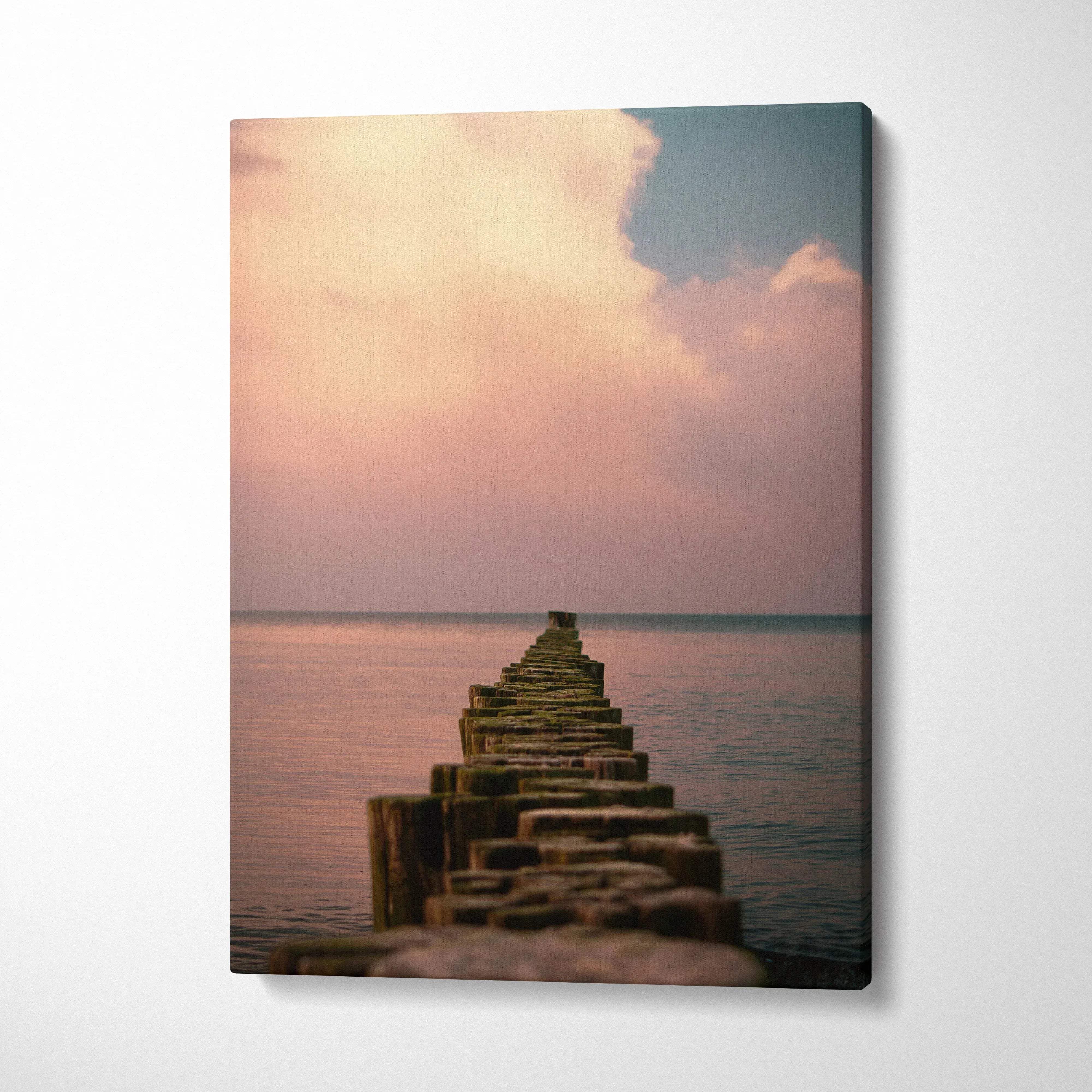 Rectangular canvas wall art print of a weathered wooden pier over calm ocean water with peach and blue twilight sky