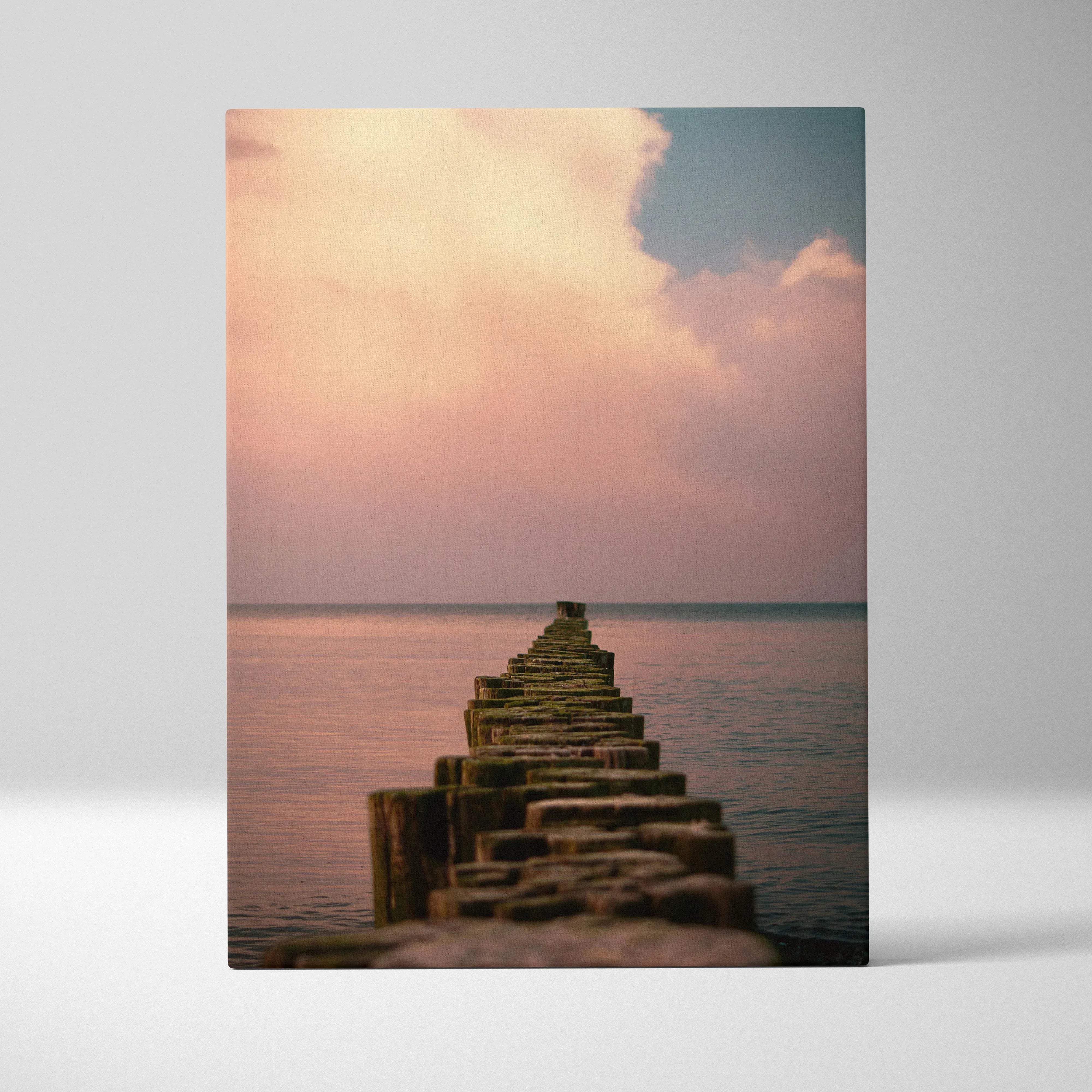 A rectangular canvas print of a weathered wooden pier over calm water with soft peach and blue twilight sky