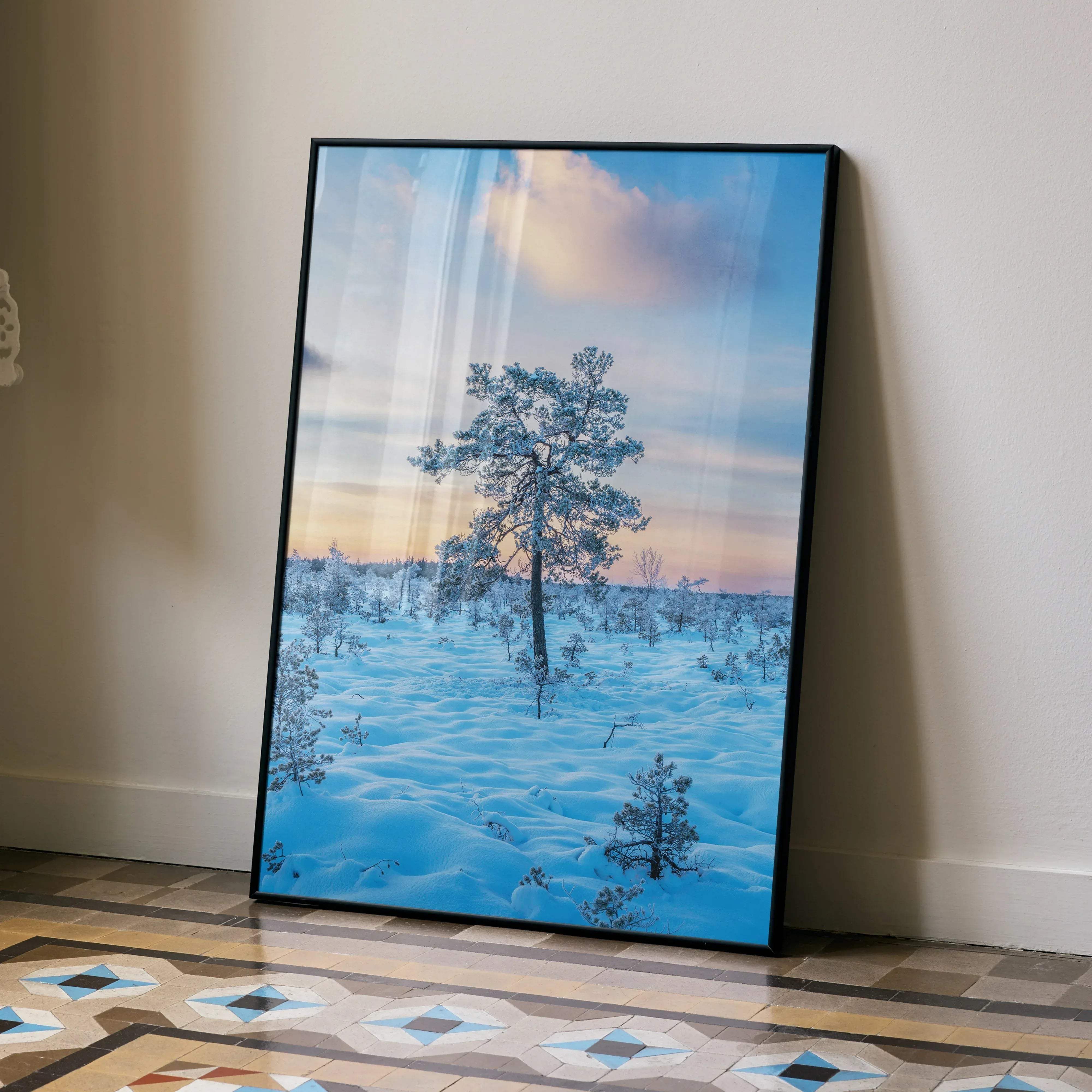 Black-framed canvas print of a solitary pine tree in snowy landscape under soft blue and pink sky vertical winter art poster