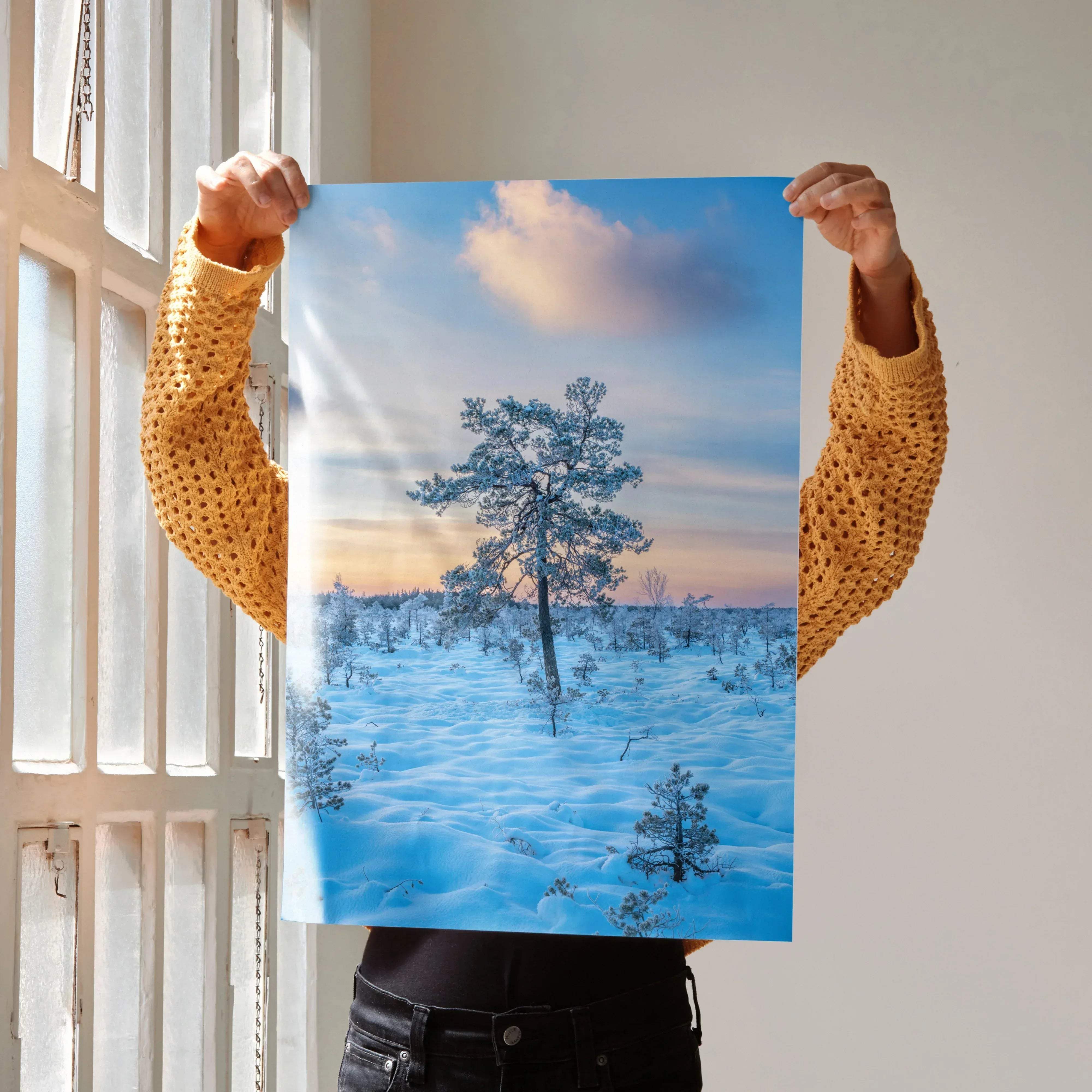 A vertical art print poster featuring a serene snowy landscape with pine trees and a pink sunset sky