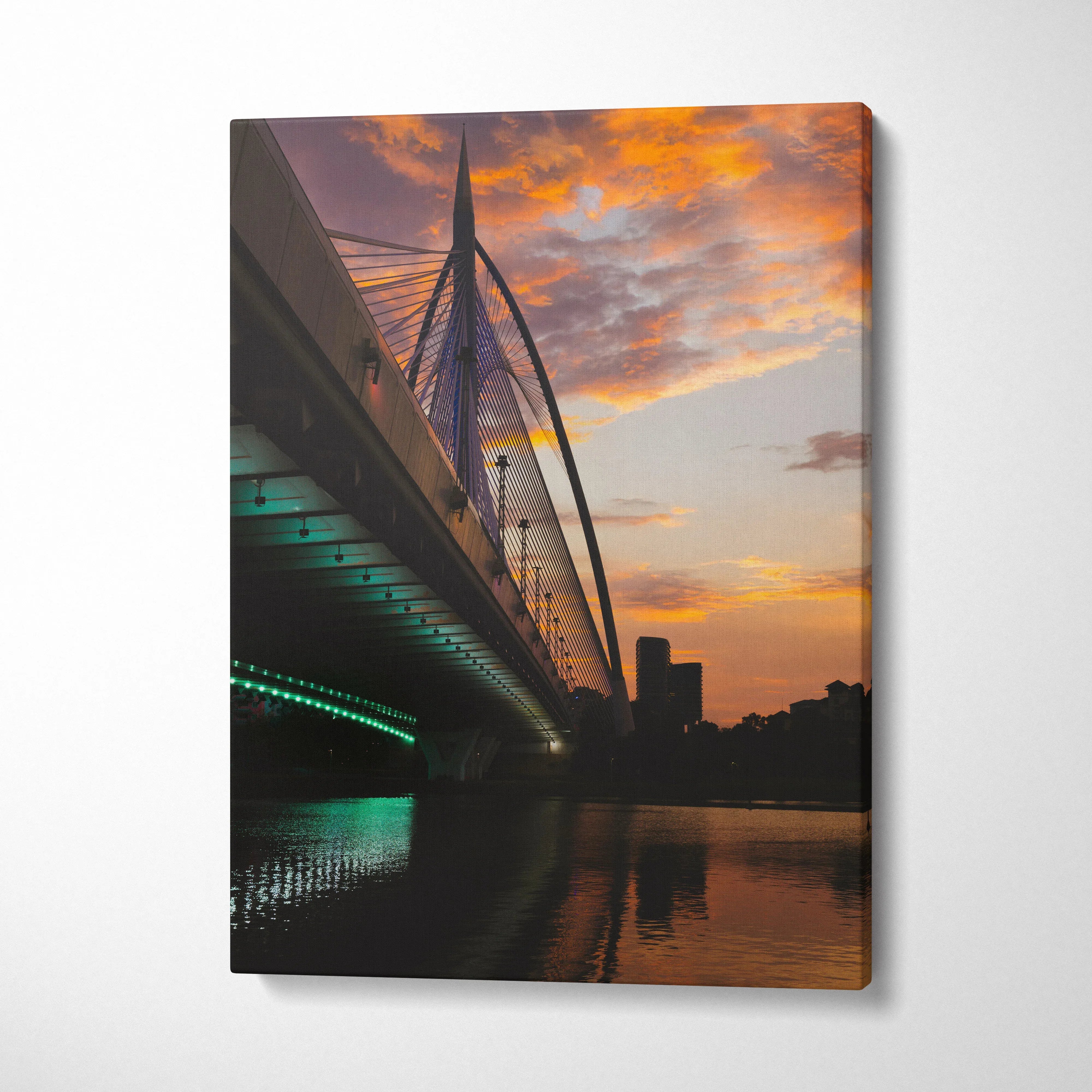 Vertical canvas wall art of city skyline at golden sunset with illuminated bridge over river.
