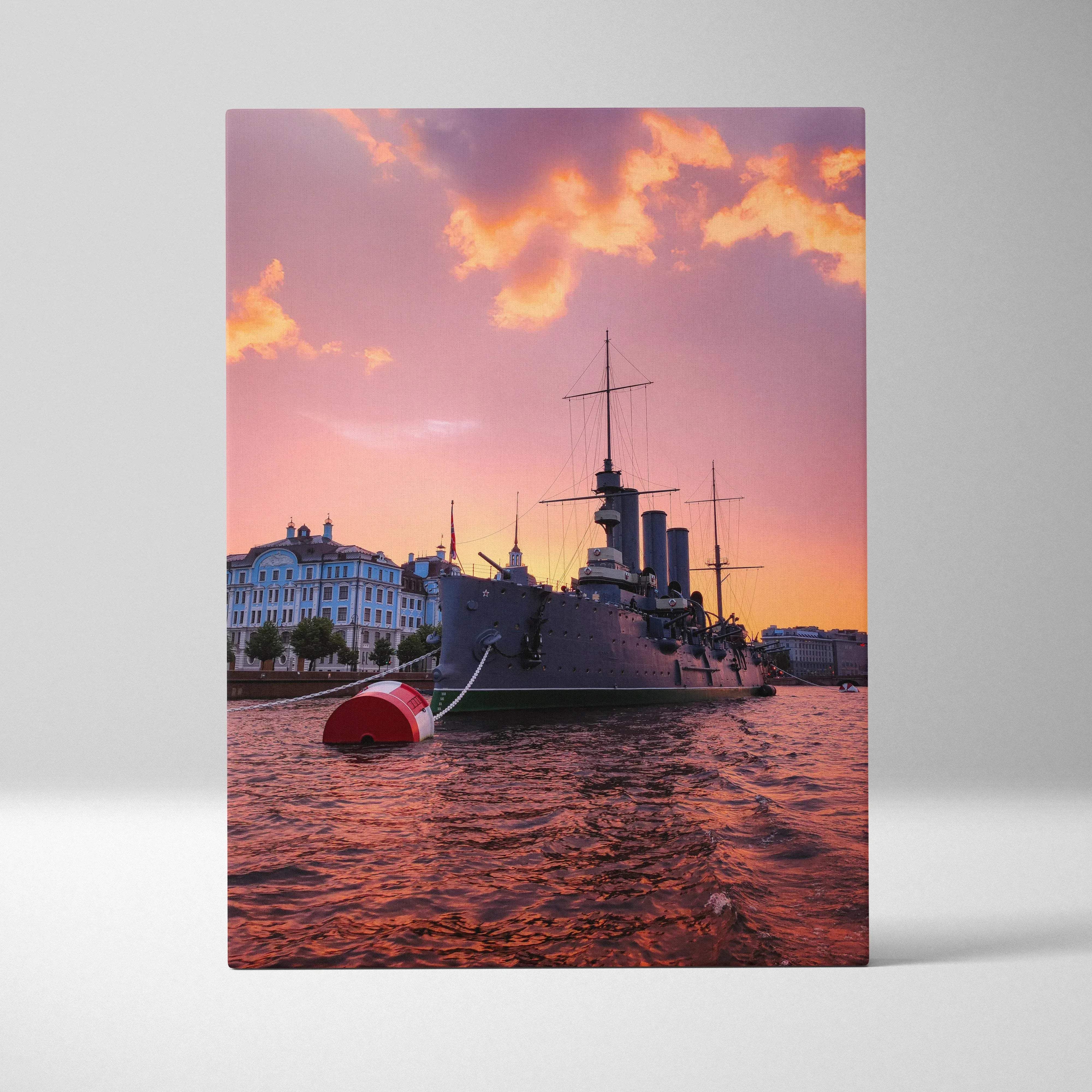 Maritime sunset harbor scene canvas wall art showing a dark gray historic warship docked under a pink and orange sky
