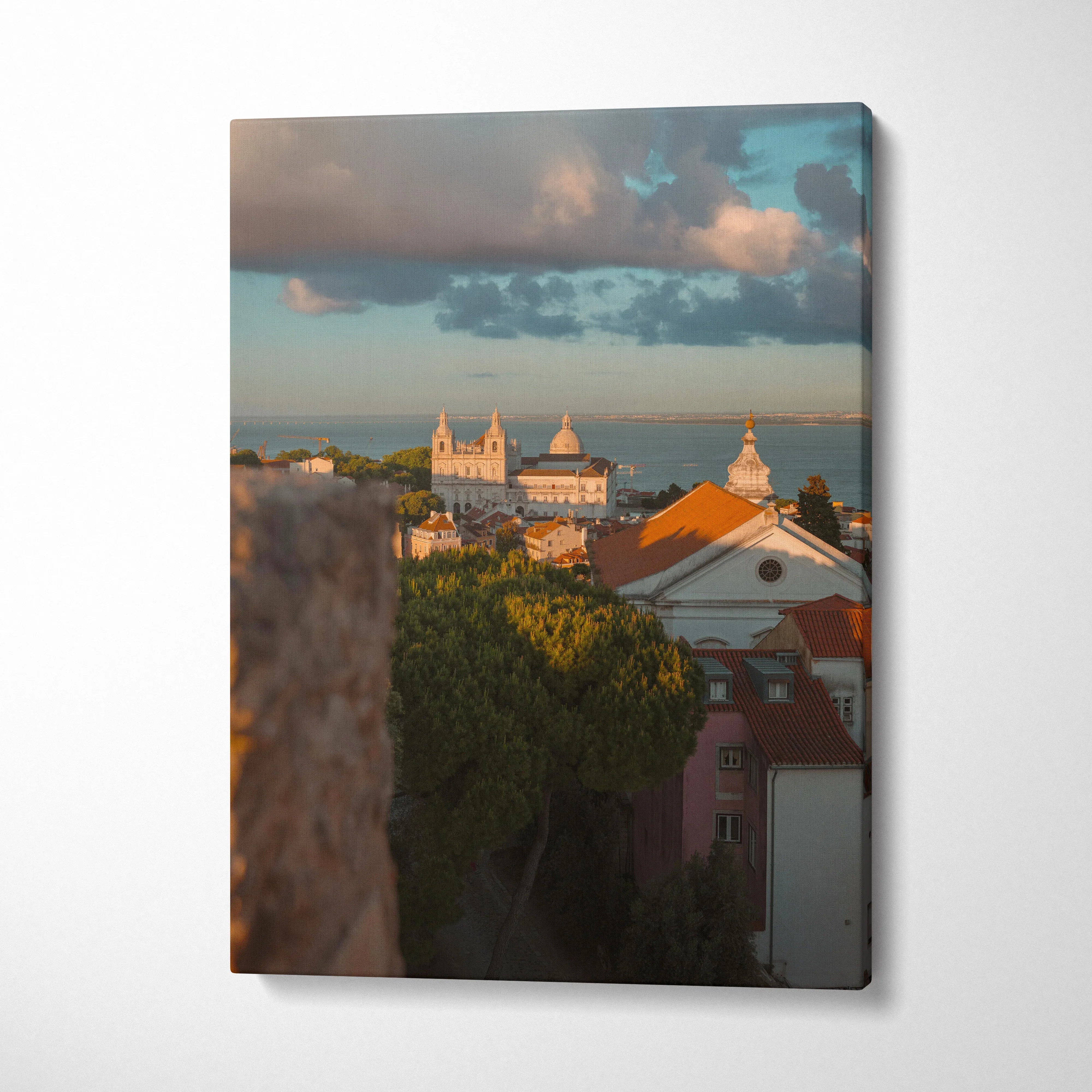 Canvas wall art featuring a cityscape at sunset with warm light on buildings and a cloudy sky.