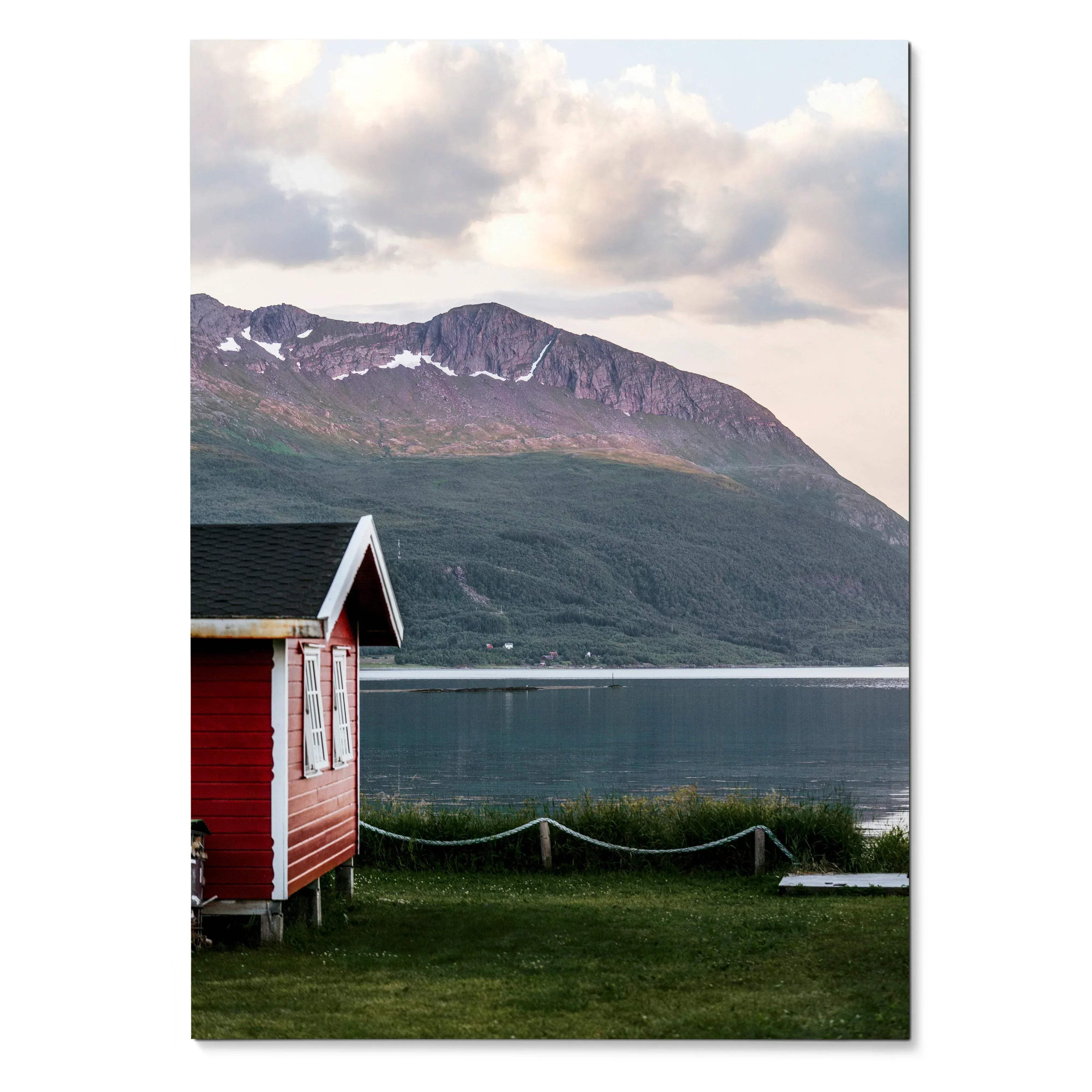 Vertical poster with red cabin by lake and green mountain under cloudy sky wall art.