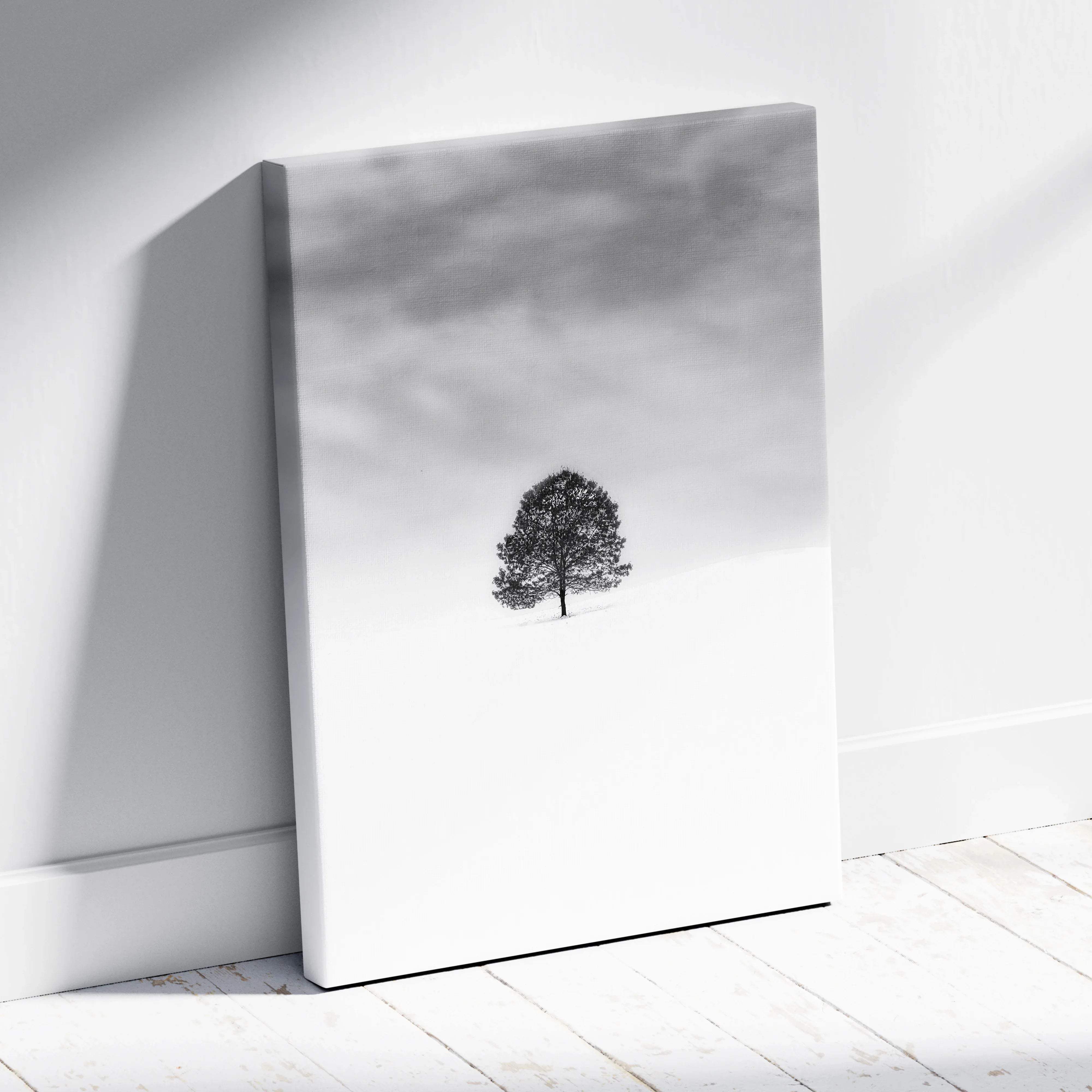 Minimalist black and white lone tree in snowy field canvas print