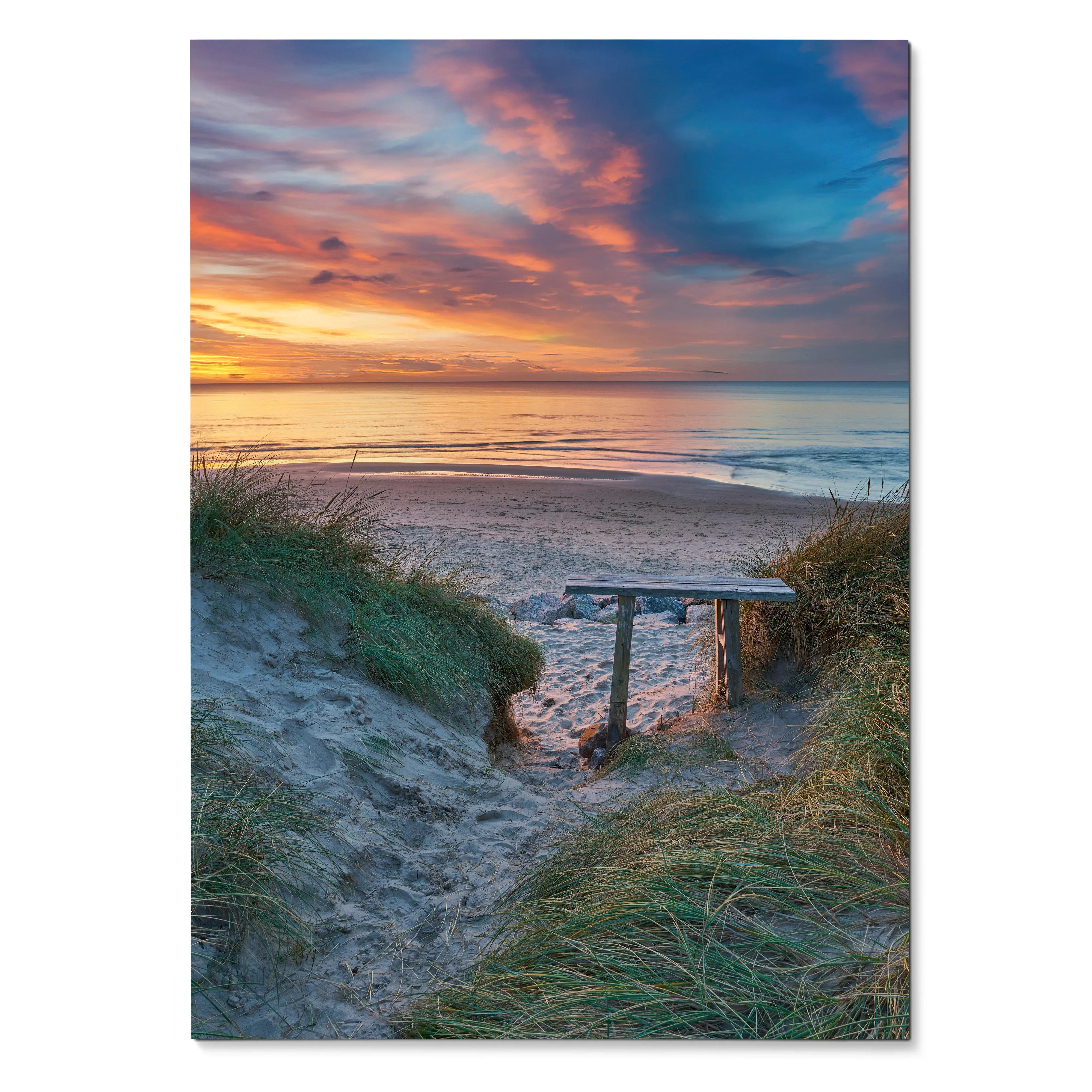 Vertical poster wall art of a vibrant beach sunset over calm ocean waves with sandy path and grassy dunes.