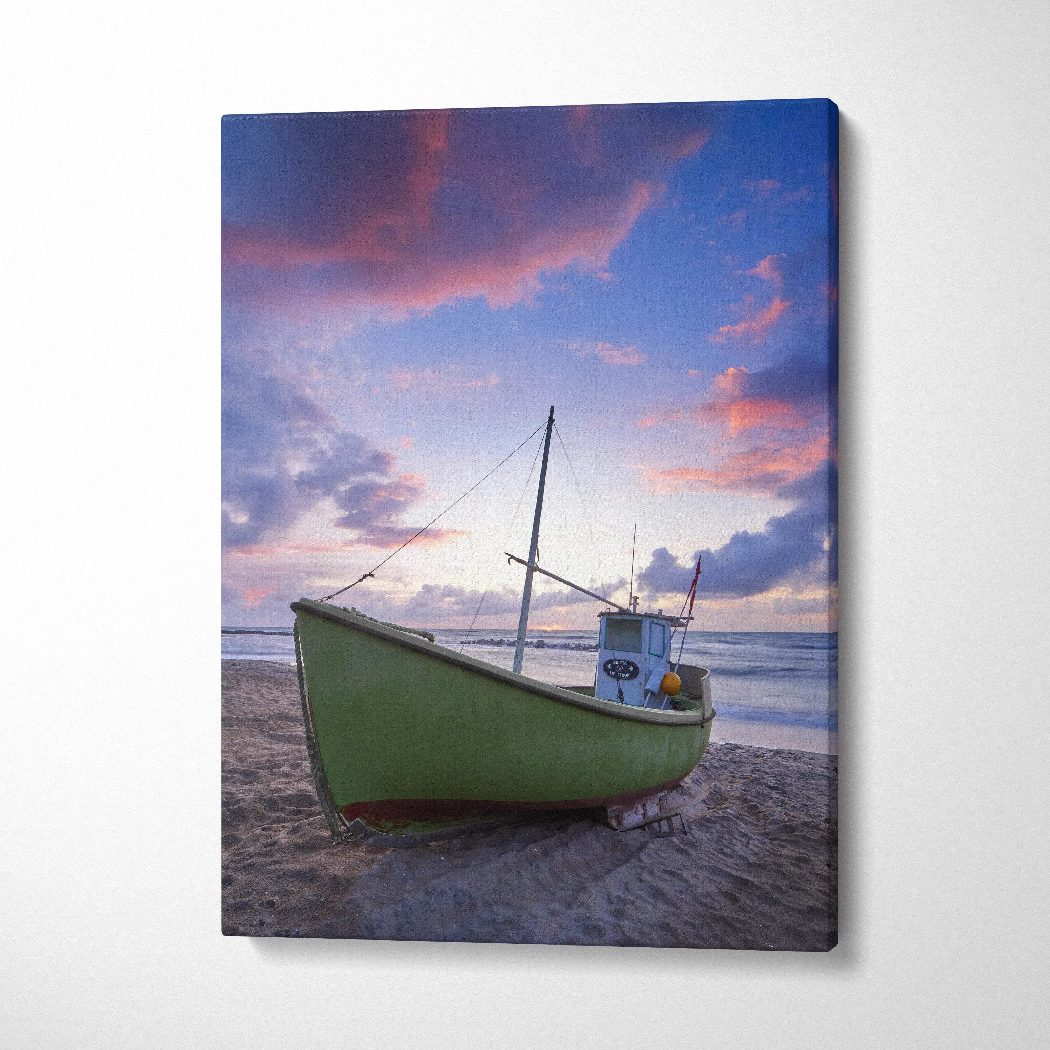 Canvas wall art featuring a green boat on a sandy beach under a colorful sunset sky.