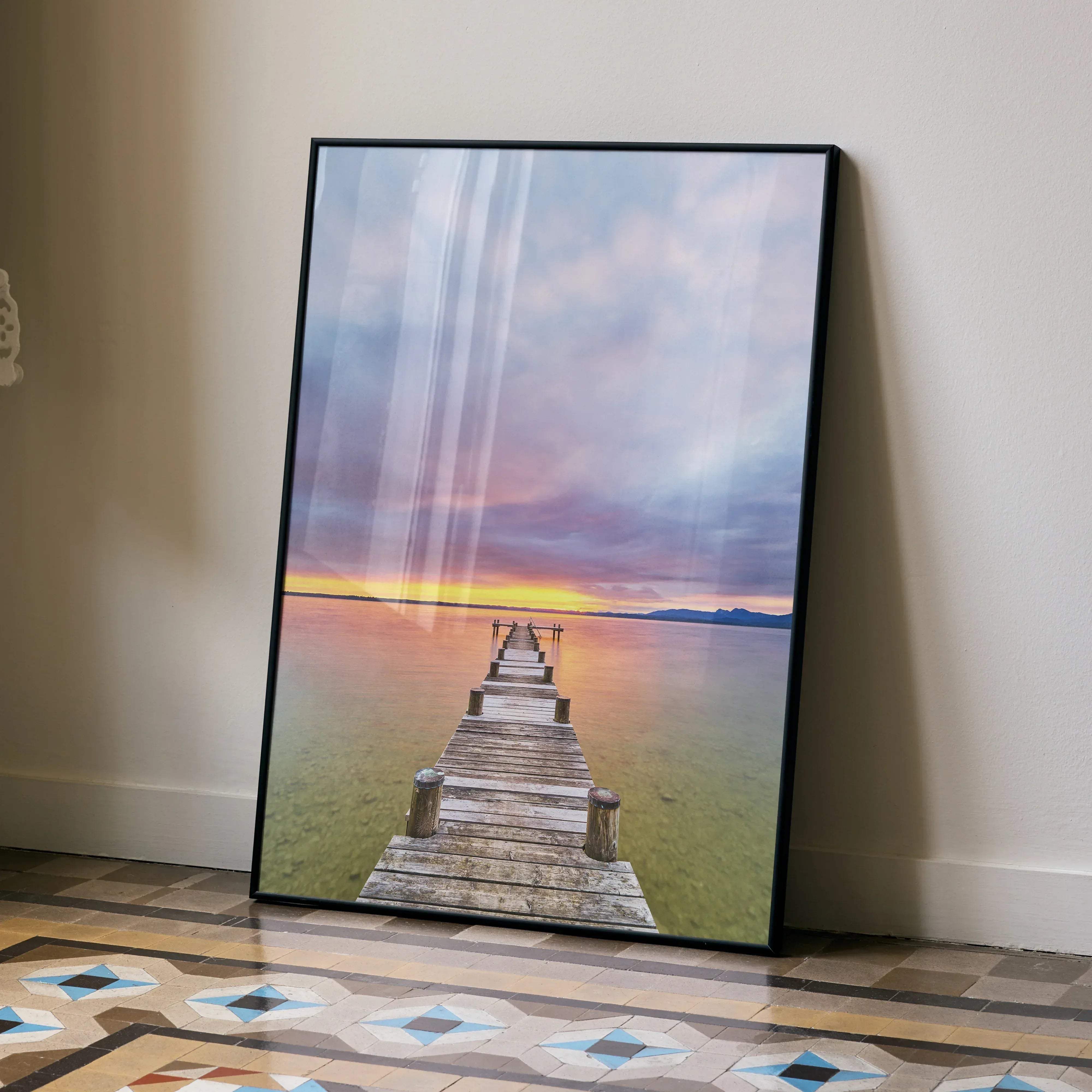 A framed canvas print of a vertical serene beach sunset ocean art featuring a wooden pier and colorful sky