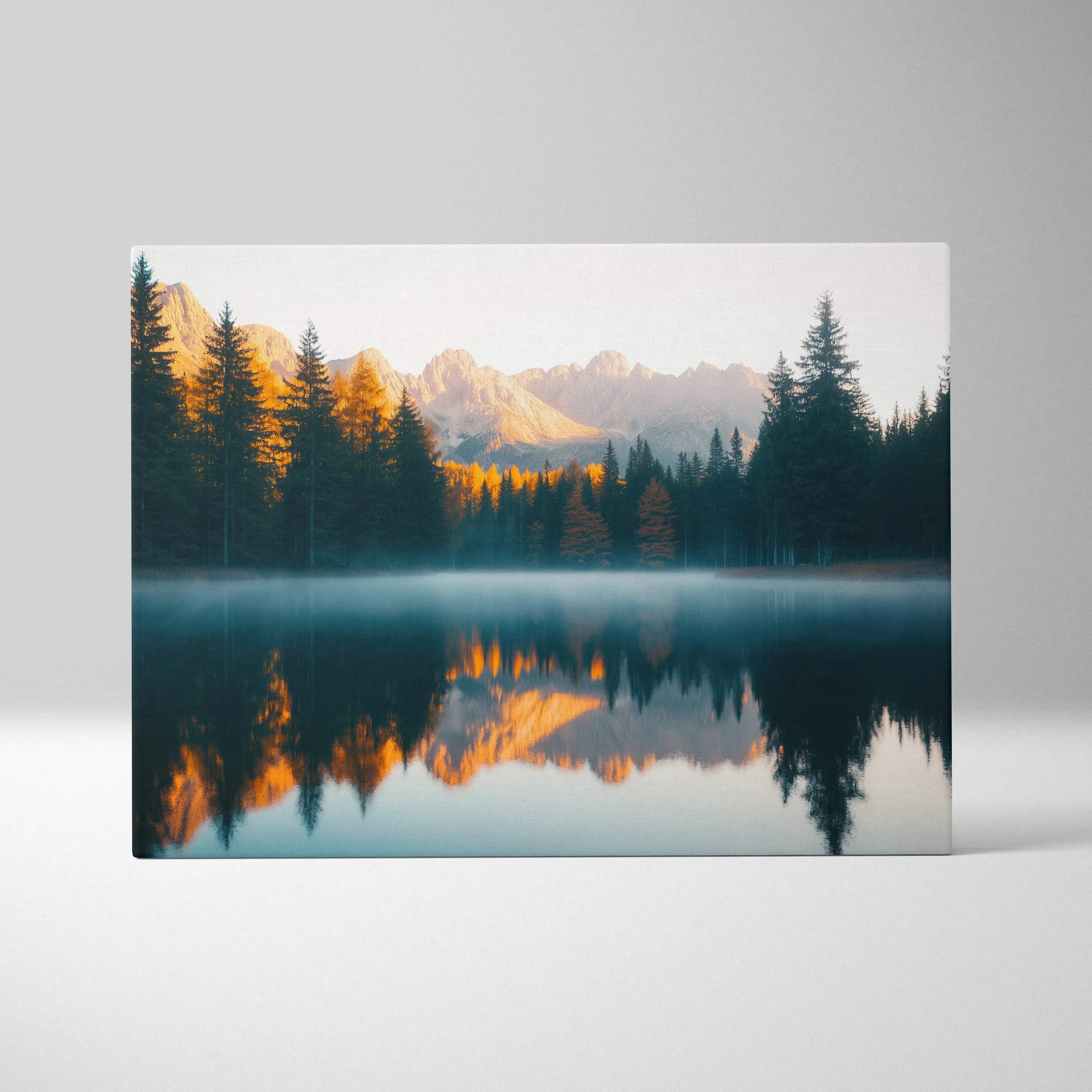 Canvas print of serene mountain lake with golden peaks and forest reflections