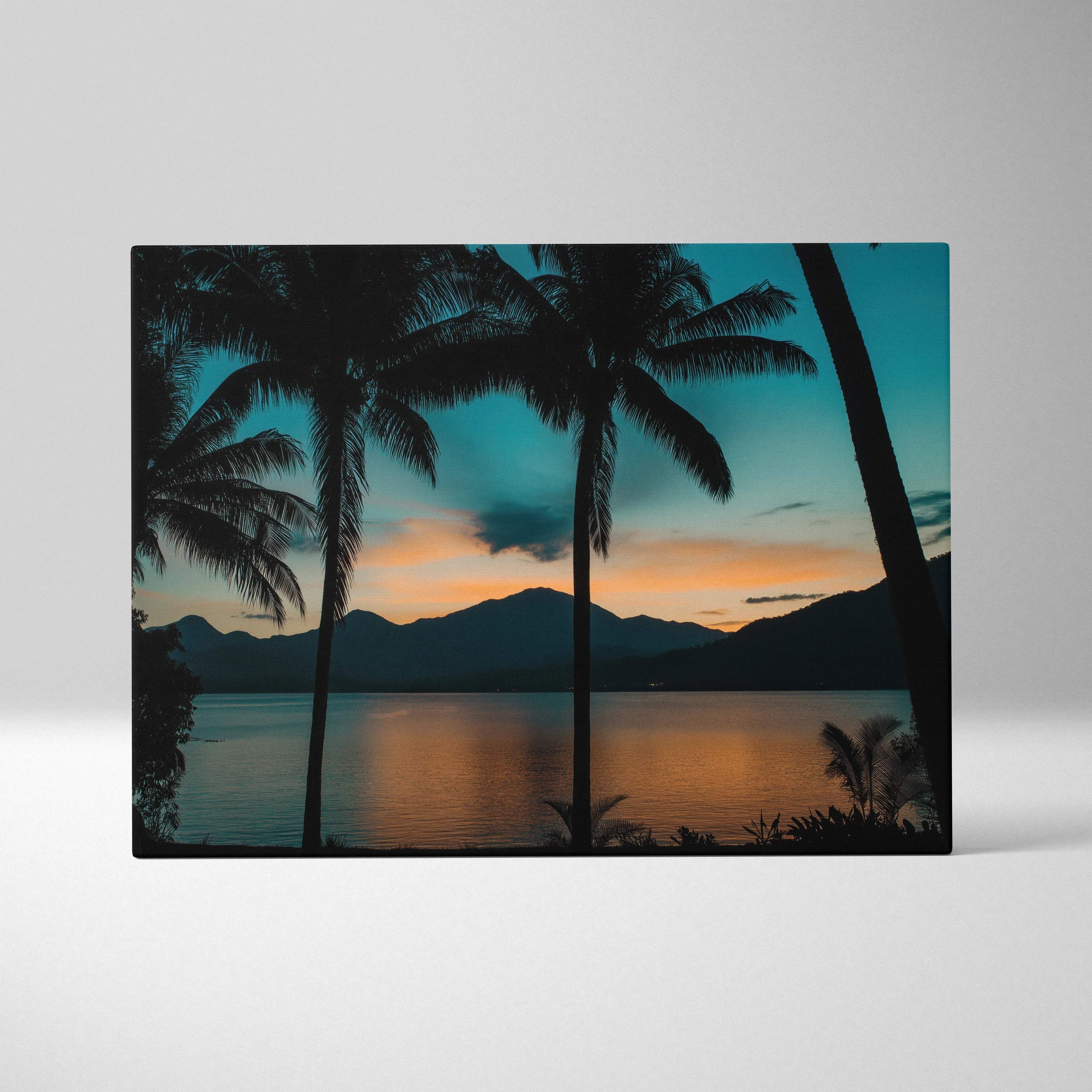 Canvas print of teal orange sunset with palm trees over mountain lake at dusk