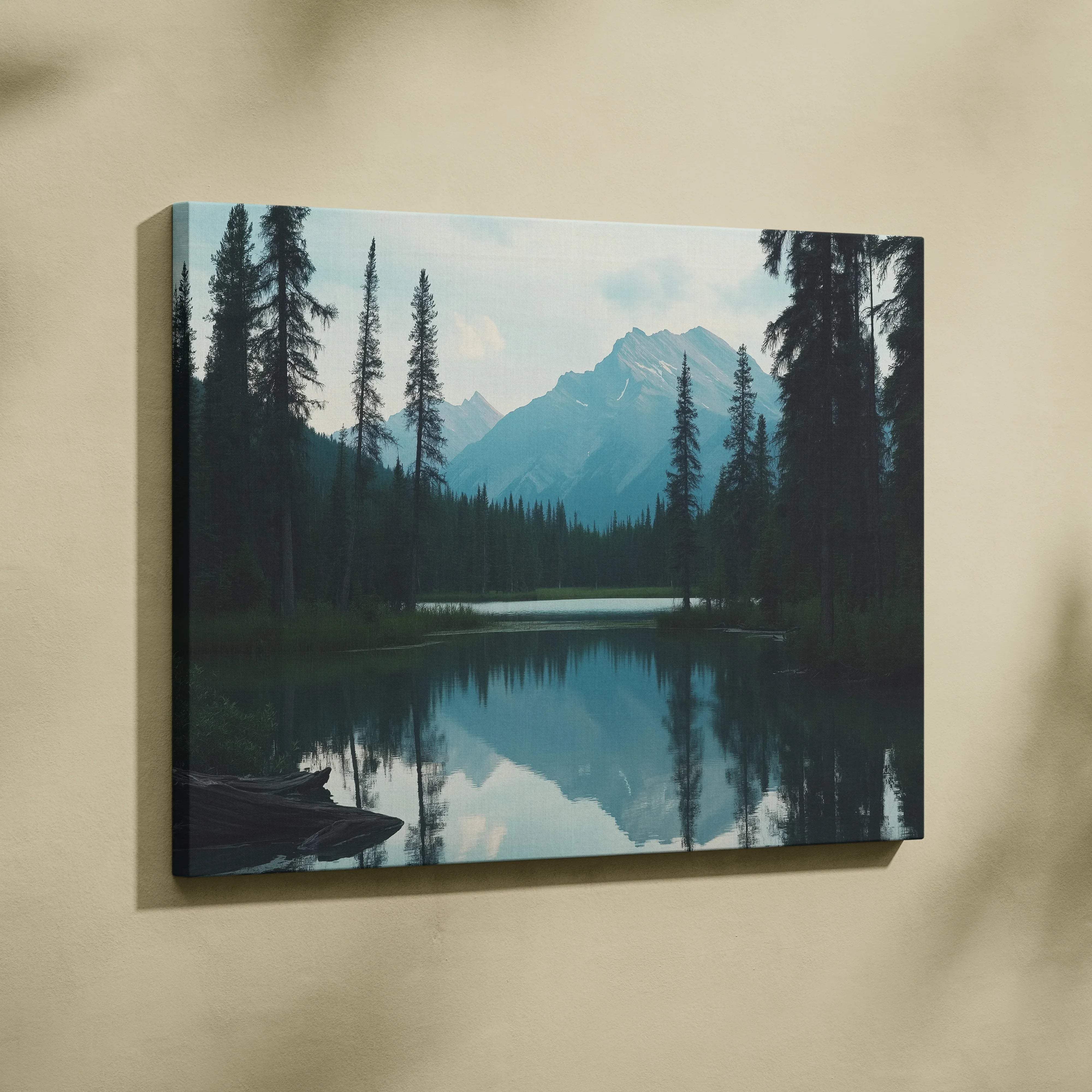 Canvas print of serene mountain lake with evergreens and snow peaks in calm blue tones