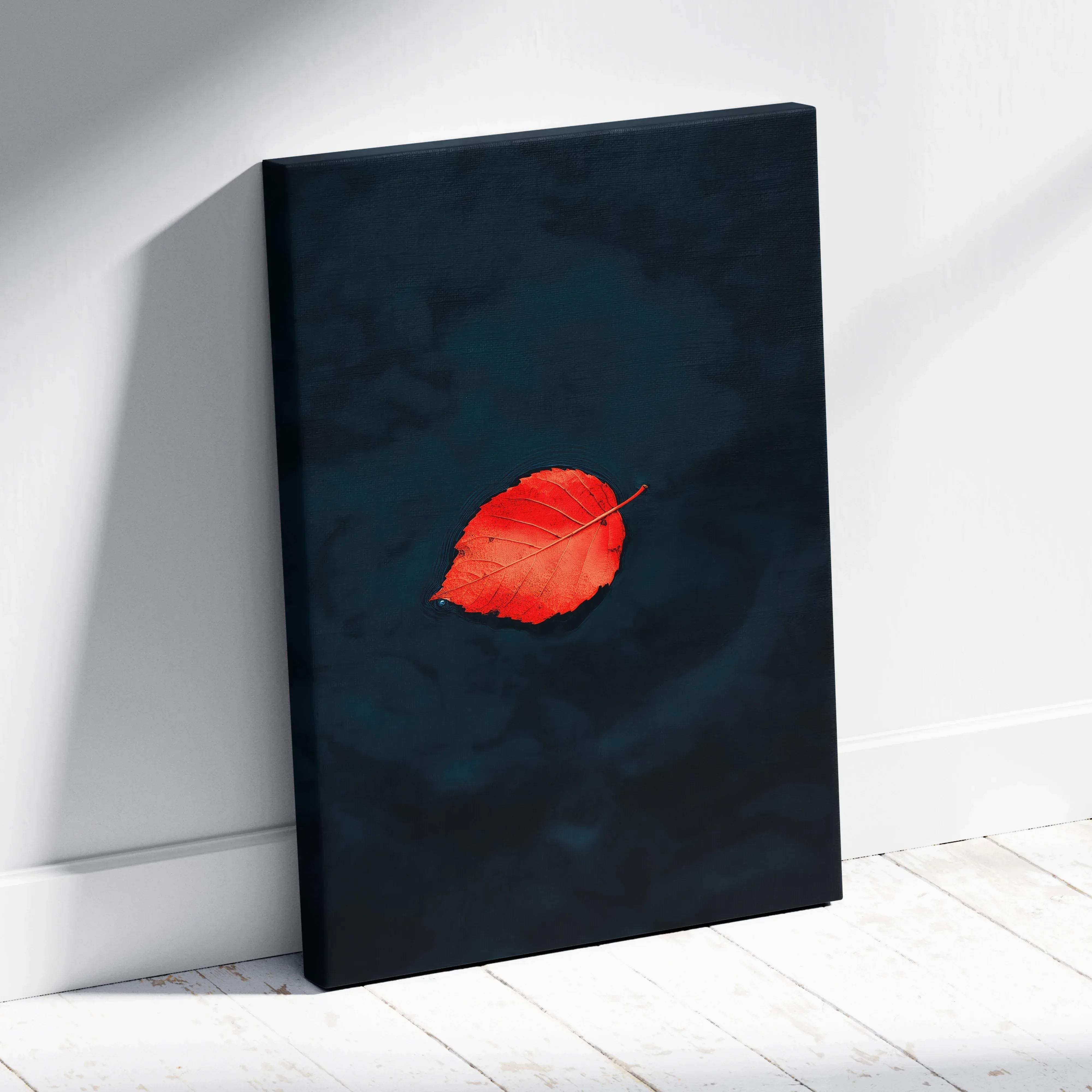 A minimalist floating canvas wall art featuring a vibrant red leaf on a deep navy background for autumn decor