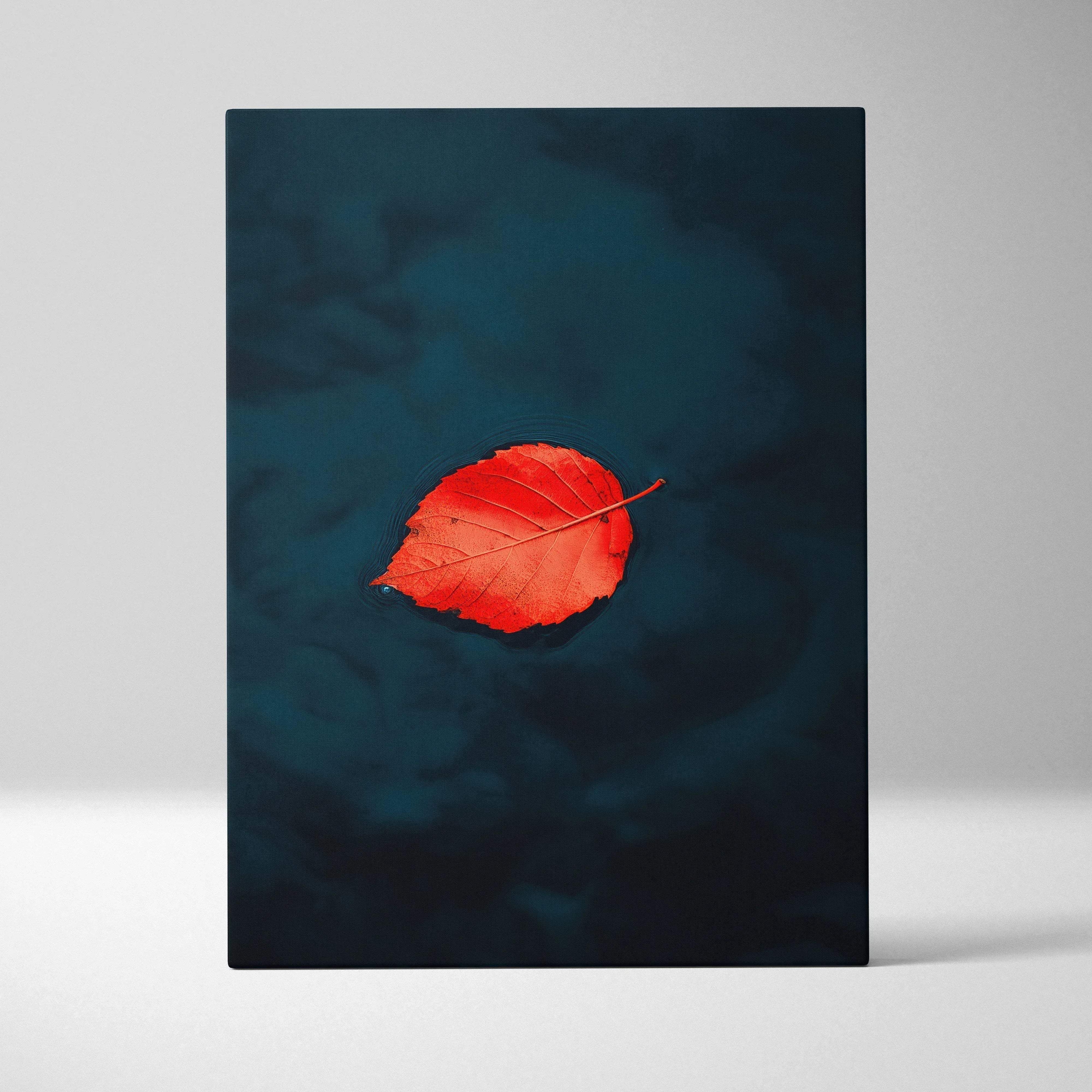 Minimalist floating canvas wall art featuring a vibrant red leaf with detailed veining on a deep navy background for autumn decor